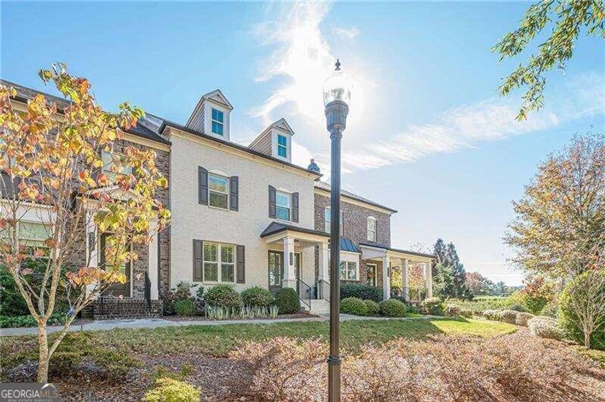 Make this YOUR HOME FOR HOLIDAYS ! Make this season beautiful and unforgettable in this  MOVE_IN_READY home and own a piece of Alpharetta . Discover Your Dream Home in Encore Walk. Welcome to your new maintenance free lifestyle in an exceptional townhome in  Alpharetta. Offering a blend of high quality and luxury . 10 foot high ceilings on the main floor and high ceilings  upstairs with hardwood floors throughout! This stunning 3-bedroom, 2.5-bathroom townhome spans three stories and showcases $30,000+ in builder  upgrades! The open concept kitchen overlooks the spacious dining area and large great room with an electric  fireplace. The kitchen is a chef's delight with white cabinets featuring soft-close technology and under-cabinet lighting,  has stainless steel appliances including a vented range hood, gas cooktop, dishwasher and built-in microwave.  A stylish white tile backsplash completes the modern look. Quartz countertops on the oversized island and  extensive kitchen counters along with a walk in pantry complete this stunning kitchen. . Step outside the  kitchen to the covered porch with electronic sun screen which encloses the space, perfect for relaxation.  Ascend the second level and retreat to the tranquility of three bedrooms and two full bathrooms. The primary  suite boasts a glamorous bathroom with customized closet. The laundry room completes this floor.  The lower level with rear entry garage, opens to a flex space perfect for an office, playroom or gym with a 1/2  bath. Each floor has it's individual thermostat. Parking is effortless with a 2-car garage and 2 additional driveway spaces. This home is walking distance to Fulton Science Academy. Being so close to downtown Alpharetta, Avalon and North Point and Interstate 400 make this location ideal!