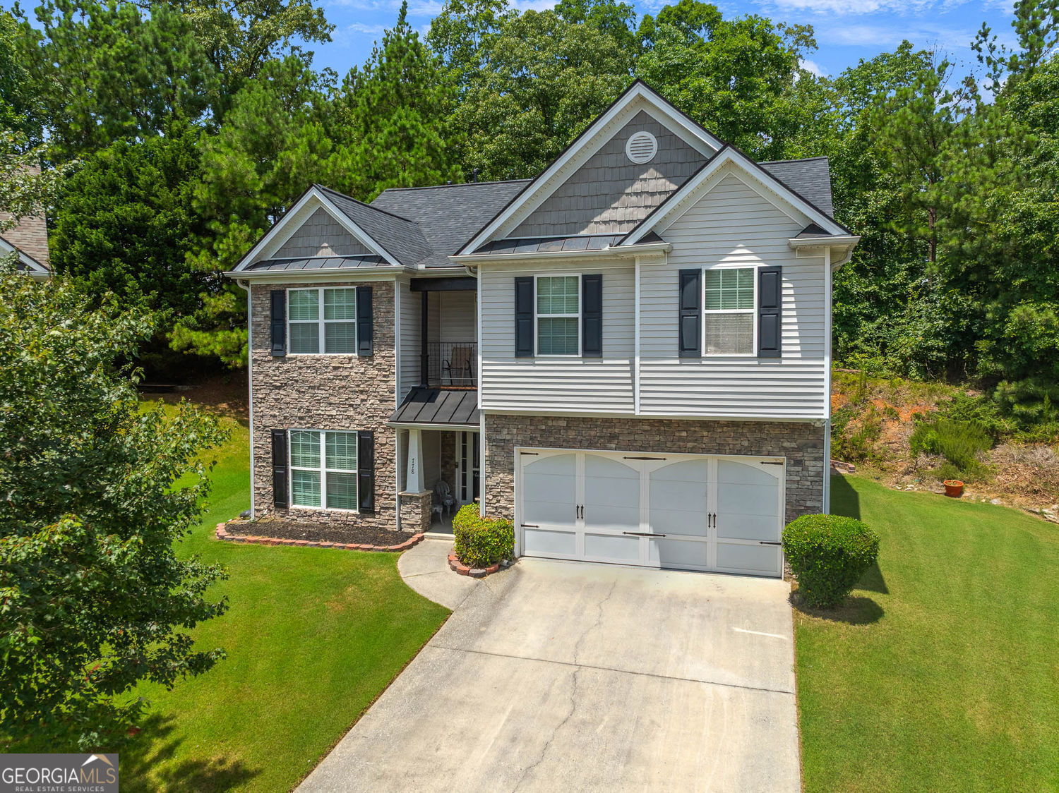 Welcome to this beautifully updated 4-bedroom, 2.5-bathroom residence, perfectly blending classic charm with contemporary features. The stunning stone and siding exterior offers wonderful curb appeal. Step inside to discover engineered hardwood floors flowing seamlessly throughout, providing a cohesive and elegant feel. The interior is currently being freshly painted, ensuring a move-in ready experience! The spacious dining room boasts a unique wood accent wall, adding character and warmth - perfect for entertaining. Enjoy the added bonus of a gorgeous glass sunroom/year-round room, not included in the main square footage, offering a serene space for relaxation or an additional living area, bathed in natural light. This home offers incredible peace of mind with significant recent upgrades: the roof and HVAC system were both replaced in 2023, and a tankless water heater was installed in 2021 for endless hot water and energy efficiency. The expansive primary suite is a true retreat, featuring private access to a charming second-floor balcony - ideal for enjoying your morning coffee or unwinding in the evenings. Interior of home was recently painted. Conveniently located just 7 minutes from the vibrant downtown shopping and restaurant scene in Sugar Hill, GA, you'll have easy access to local amenities, entertainment, and dining options. Don't miss the opportunity to make this meticulously maintained and thoughtfully updated home your own!