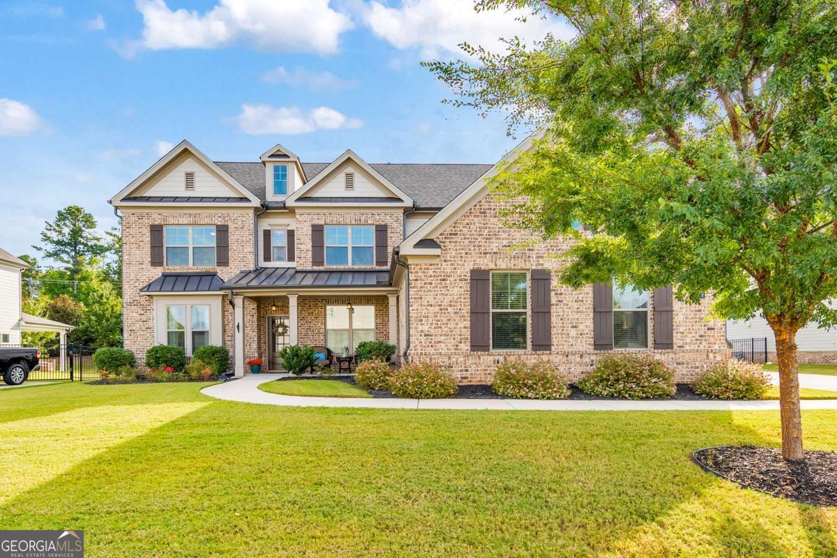 This timeless beauty is ready for you to move right in! Welcome to this stunning 5 bed / 4.5 home built in 2019 that blends modern comfort with elegant design. From the moment you step inside, the open floor plan creates a bright and inviting atmosphere, perfectly suited for both everyday living and entertaining. The gourmet kitchen is a chef's dream, complete with double ovens, a gas cooktop, vent hood, granite countertops, stainless steel appliances, and white soft-close cabinetry that offers both style and functionality. A breakfast bar and eat-in dining space overlook the two-story great room, where a floor-to-ceiling stone fireplace and a wall of windows flood the home with natural light. The main level also features a formal dining room ideal for hosting dinner parties, a private office with French doors for working from home, and a guest suite with a full ensuite bath. A powder room adds convenience for guests, while detailed trim and thoughtful finishes elevate the character throughout. Hardwood floors extend across the main living areas. Upstairs, the primary suite serves as a true retreat with tray ceilings and a spa-like bath that includes a double vanity, soaking tub, a separate glass-enclosed shower, and an oversized walk-in closet.Secondary bedrooms include a Jack & Jill bath shared between two rooms and an additional bedroom with its own ensuite bath. The laundry room is also conveniently located on the upper level. All bathrooms feature granite countertops and timeless tile finishes. Step outside to the covered patio, the perfect outdoor oasis for relaxing or watching sunsets with family and friends. The three-car garage provides ample parking and storage. This home is nestled in a beautiful neighborhood that offers a scenic lake with a path, providing a peaceful backdrop for evening strolls. Located within award-winning school districts, this home combines luxury living, modern convenience, and an unbeatable setting. Don't miss the opportunity to make this exceptional property your own.