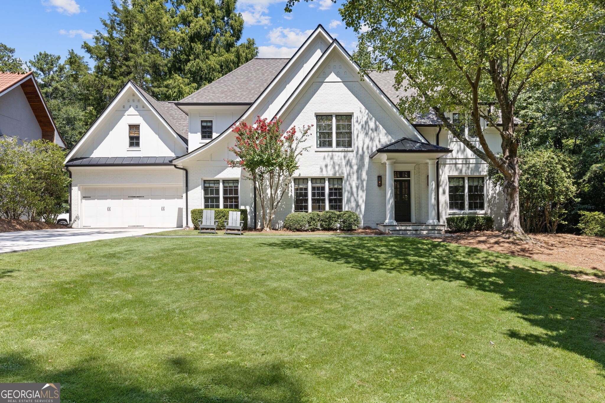 Welcome to a rare gem in the heart of Buckhead! A beautifully renovated Tudor style home set on an exceptionally private, flat 1 acre lot, perfectly positioned across from a serene nature preserve. This elegant 5-bedroom, 4.5-bathroom home offers the best of sophisticated living filled with charm, character, warmth and modern touches. Step inside to discover a magazine worthy home, with an effortless flow that's perfect for both everyday living and entertaining. The main floor offers a dedicated office space, large dining room and a show stopping great room with soaring vaulted, beamed ceilings. The gourmet kitchen has been recently renovated and features beautiful quartz countertops and top-of-the-line appliances. The kitchen opens to a cozy keeping room with a double-sided fireplace shared with the dining room, creating the perfect setting for gathering and conversation. Ideal for guests, the main floor also offers a bedroom and ensuite bathroom. Upstairs, the home's thoughtful layout includes a loft space, spa-inspired, vaulted primary suite with fireplace, three additional bedrooms, two additional bathrooms and a laundry room with sink and incredible storage. The flat backyard offers the ultimate blank canvas, ready for your dream pool or outdoor oasis. This home truly is a can't miss! A rare combination of privacy, location, and timeless design just minutes from the best of Buckhead!