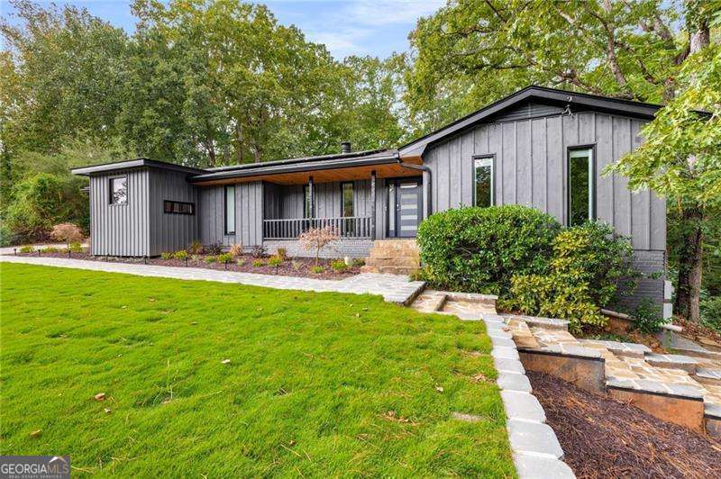 If one-of-a-kind design, energy resilient, and a home made for entertaining are on your list, you've just met your match. Set atop a lush, landscaped lot surrounded by trees, this modern ranch has undergone a complete transformation, inside and out. From the energy-resilient geothermal + solar + Tesla Powerwalls for low bills and whole-home backup, to the kitchen worthy of its own magazine spread, to the spa-style saltwater pool, every detail has been designed with luxury and functionality in mind. The main level features a white oak kitchen with custom made butcher block counters, Italian appliances, a six-burner stove, dual ovens, and wine cooler. Just around the corner, a secondary prep kitchen and 400-bottle wine cellar mean you're ready to host. The primary suite addition is a retreat all its own, with heated tile floors, an MTI air-jet soaking tub, Grohe fixtures, fog-free mirrors, and custom built-ins that make every morning feel like a spa day. Throughout the home, you'll find quality updates like hardwood floors, solid wood interior doors, and energy-efficient windows. Downstairs, you'll find a fully finished lower level with a stylish bar, Dolby Atmos theatre, and space that easily flexes for guests or a home office. The exterior is showshopping with new landscaping and resurfaced retaining walls wrapped in Corten steel with soft recessed lighting. Multiple outside spaces really are an entertainer's dream - a beautifully resurfaced pool with a new salt cell system and upgraded Aqualink automation, a serene lower deck tucked in the trees, complete with a gas line, and a terraced, sun-soaked lounging area. All of this is tucked away in the perfect location in Roswell: think farmers markets, live music on Canton Street, and cozy coffee shops tucked between boutiques and locally owned restaurants. On weekends, stroll the Roswell Mill ruins, kayak the Chattahoochee River, and enjoy all Roswell has to offer.