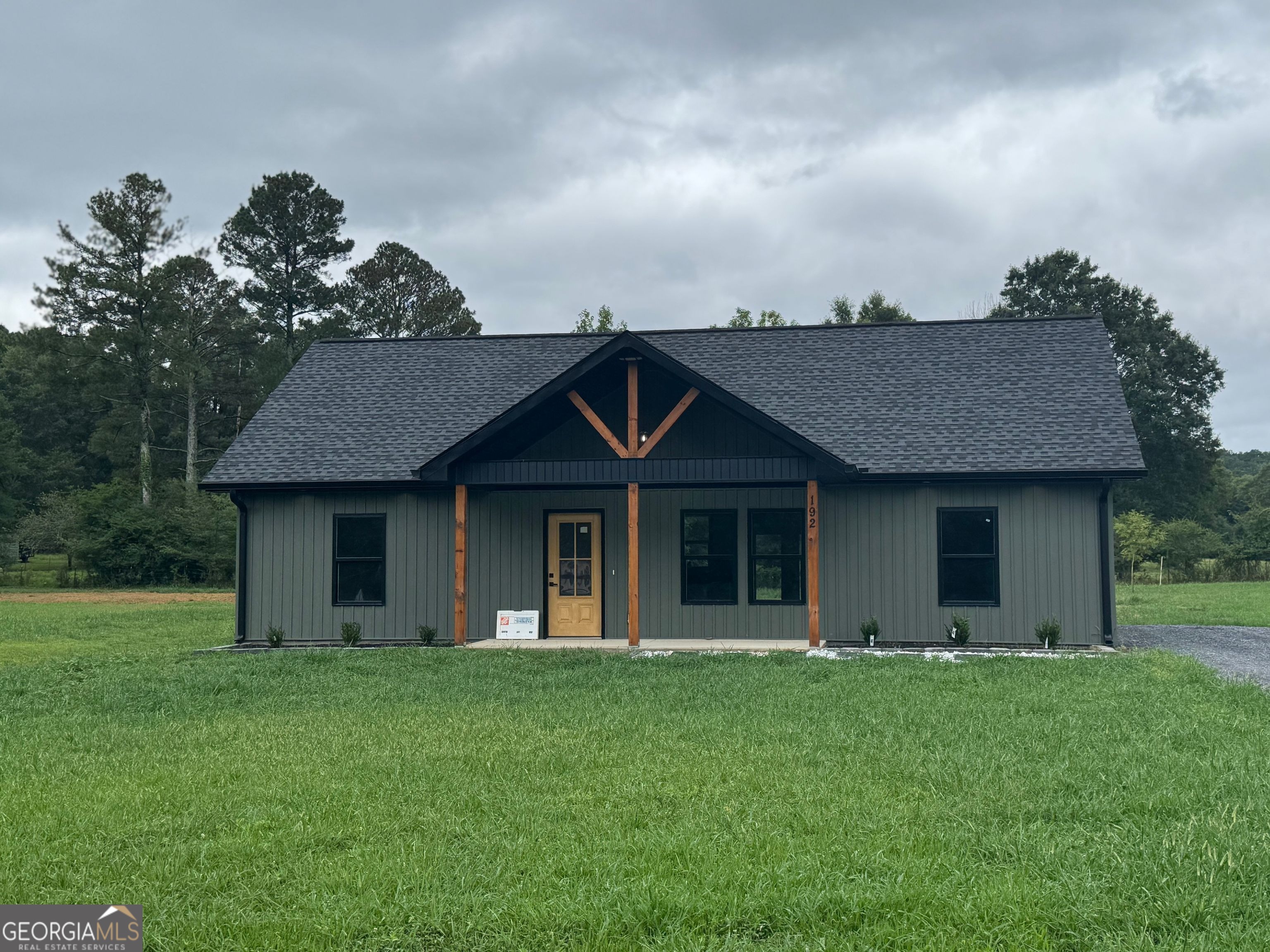 Welcome to this beautifully newly built home in the serene town of Plainville, GA. Situated on a generous .61-acre lot, this 3-bedroom, 2-bathroom home offers a perfect blend of comfort and modern design, making it an ideal choice for anyone looking for peace and privacy without sacrificing convenience. The open-concept living space features granite countertops in the kitchen, paired with a full-size pantry, offering plenty of room for storage and culinary creativity. The primary suite includes a spacious walk-in closet, while the bathrooms are finished with elegant tile showers. Step outside to enjoy a large backyard-perfect for family gatherings, gardening, or just unwinding in a quiet, spacious setting. This home is nestled in a quiet neighborhood, providing the perfect retreat while still being conveniently close to local amenities.