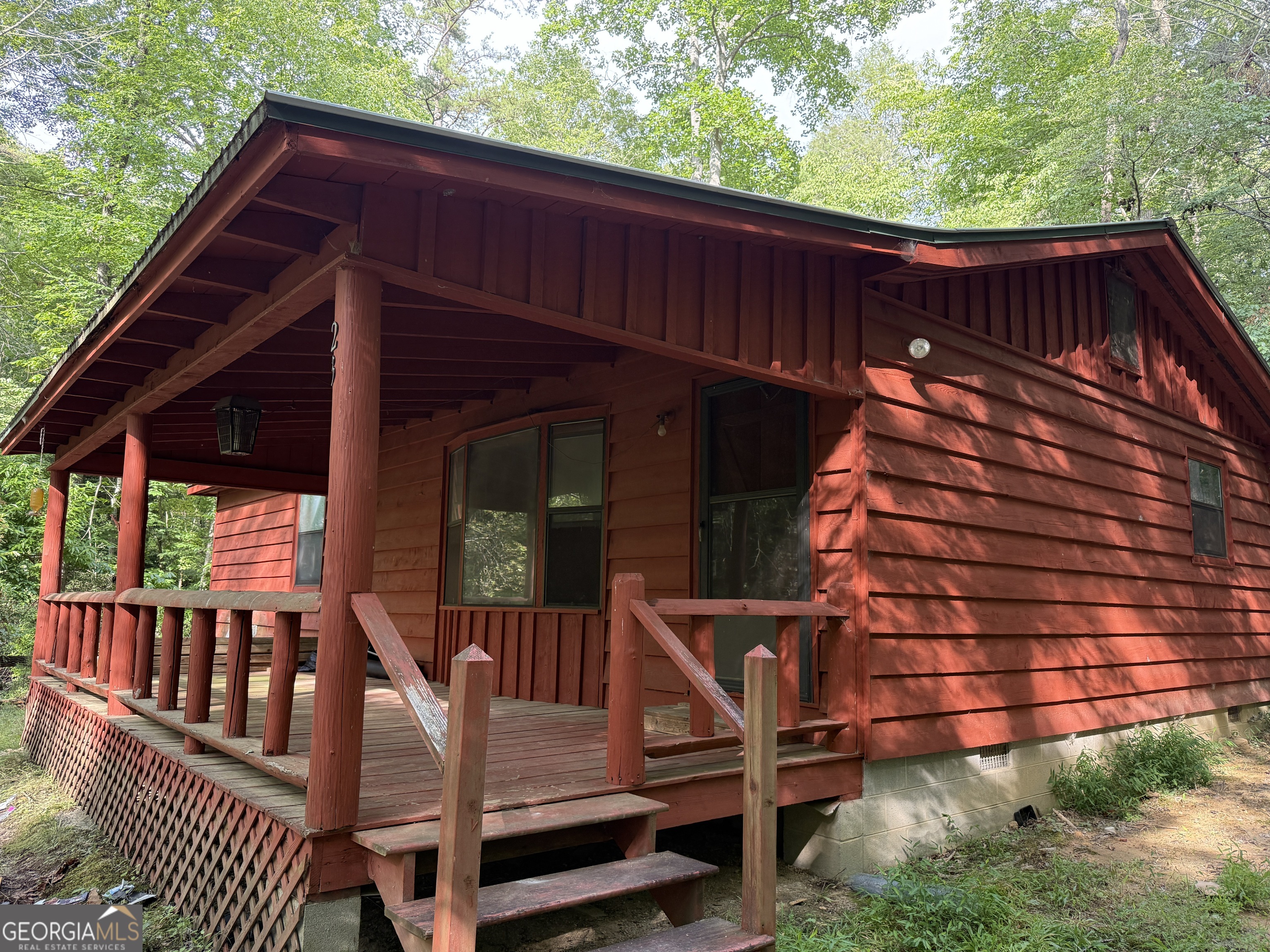 PRICED TO SELL! Tucked away in a private, wooded 1.01 acre lot in Fannin County's Briar Cove gated community, this cozy 2-bedroom, 2-bathroom cabin offers the perfect blend of seclusion and potential. Whether you're searching for a short-term rental investment, full-time residence, or a weekend escape to the North Georgia mountains, this home checks all the boxes. Step onto the oversized front porch and take in peaceful views of a private pond - the ideal spot for morning coffee or evening relaxation. The new flooring, new well, recent survey, and recent septic inspection gives you a head start on bringing this property to its full potential. Located in a gated community, this property offers security and privacy, with towering trees surrounding the cabin for a true mountain retreat feel. Don't miss the opportunity to own a slice of North Georgia paradise with water views, privacy, and potential!