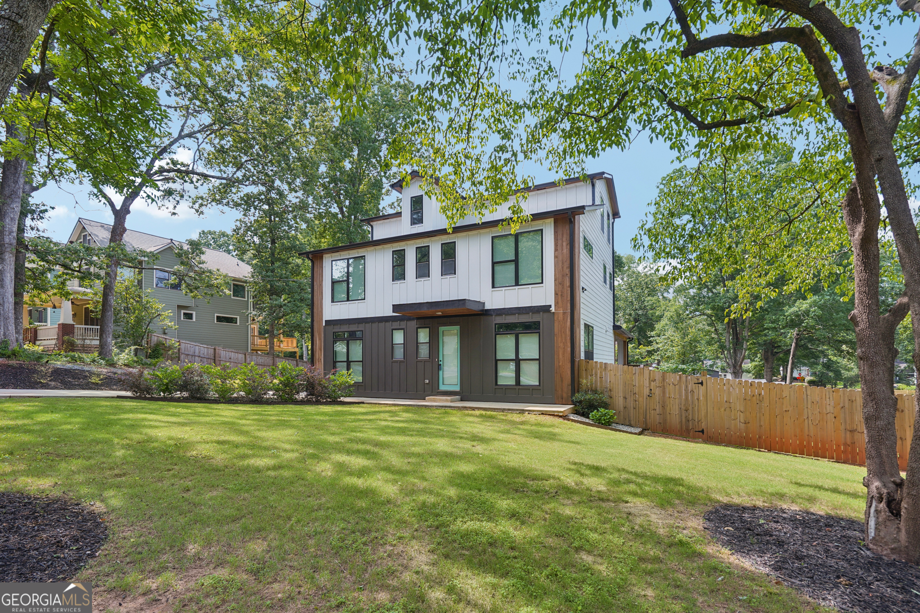 Experience elevated living in this stunning three-level luxury home, where high-end finishes and thoughtful design meet in perfect harmony. From the moment you enter, you're welcomed by gorgeous hardwood floors that flow throughout the home, setting the stage for elegant and cohesive living. The heart of the home is the gourmet kitchen, featuring quartz countertops, designer tile backsplash, a 36" upscale cooktop, stainless steel appliances, pot filler, and a custom vent hood that adds both function and flair. Just off the kitchen is the sunlit open-concept living area with a sleek wet bar-ideal for entertaining-and a spacious walk-in pantry complete with quartz counters, custom cabinetry, a bonus prep sink, and a wine fridge. Upstairs, the luxurious owner's suite offers a private retreat with oversized closets and a spa-like bath showcasing a soaking tub, double quartz vanities, beautifully tiled walls, and an oversized shower. This level also features three additional large bedrooms and two stylish full bathrooms, offering space and comfort for family or guests. The well-appointed laundry room includes a custom doggy shower, perfect for pet lovers. On the third level, you'll find a private bedroom, full bath, wet bar (mini fridge to be installed), and a cozy living area-ideal for guests, a home office, or bonus entertaining space. Step outside to the elevated back deck overlooking a landscaped backyard, where a 6-foot wooden privacy fence (to be installed) will create a peaceful outdoor escape. Rounding out this incredible home is the two-car garage with an electric vehicle charging plug, blending modern convenience with future-ready functionality. Located just minutes from Decatur, East Lake Golf Course, the Beltline, and major highways (I-285/I-20), this home offers the perfect combination of luxury, comfort, and convenience-don't miss the opportunity to make it yours.