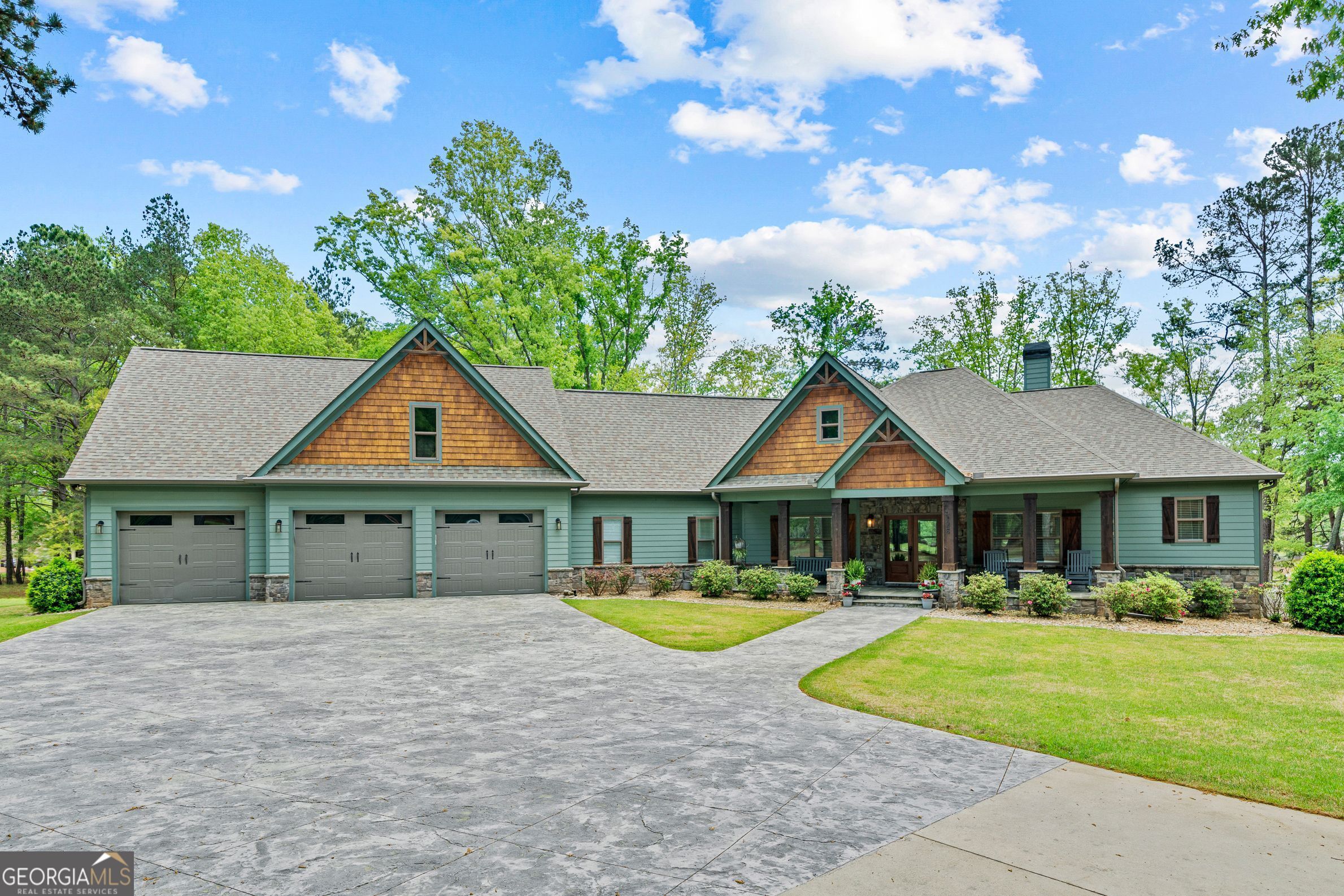 AMAZING LAKE OCONEE ESTATE HOME! One-of-a-kind lakefront home situated on two lakefront lots, featuring two maximum docks, 3.4 acres of land, a detached four-car heated/cooled garage with a bathroom, a resort-style swimming pool, all located in one of the best and most convenient locations on the lake. High-quality, Craftsman-style home in like-new condition with an inviting covered front porch and attached 3-car side entry garage. Main floor features an open floor plan, hardwood floors, vaulted living room with stone fireplace, gourmet kitchen, master bedroom suite with lake view, deck access, and luxurious bathroom, 3 additional bedrooms, and a vaulted/screened deck facing the lake. Full walk-out basement features a large family room with wet bar, 9-seat theater, bathroom, other/bedroom, and a huge storage/workshop area leading out to a covered patio, relaxing swimming pool, and gorgeous views of Lake Oconee. You won't find anything like this property, so hurry if you want the best!