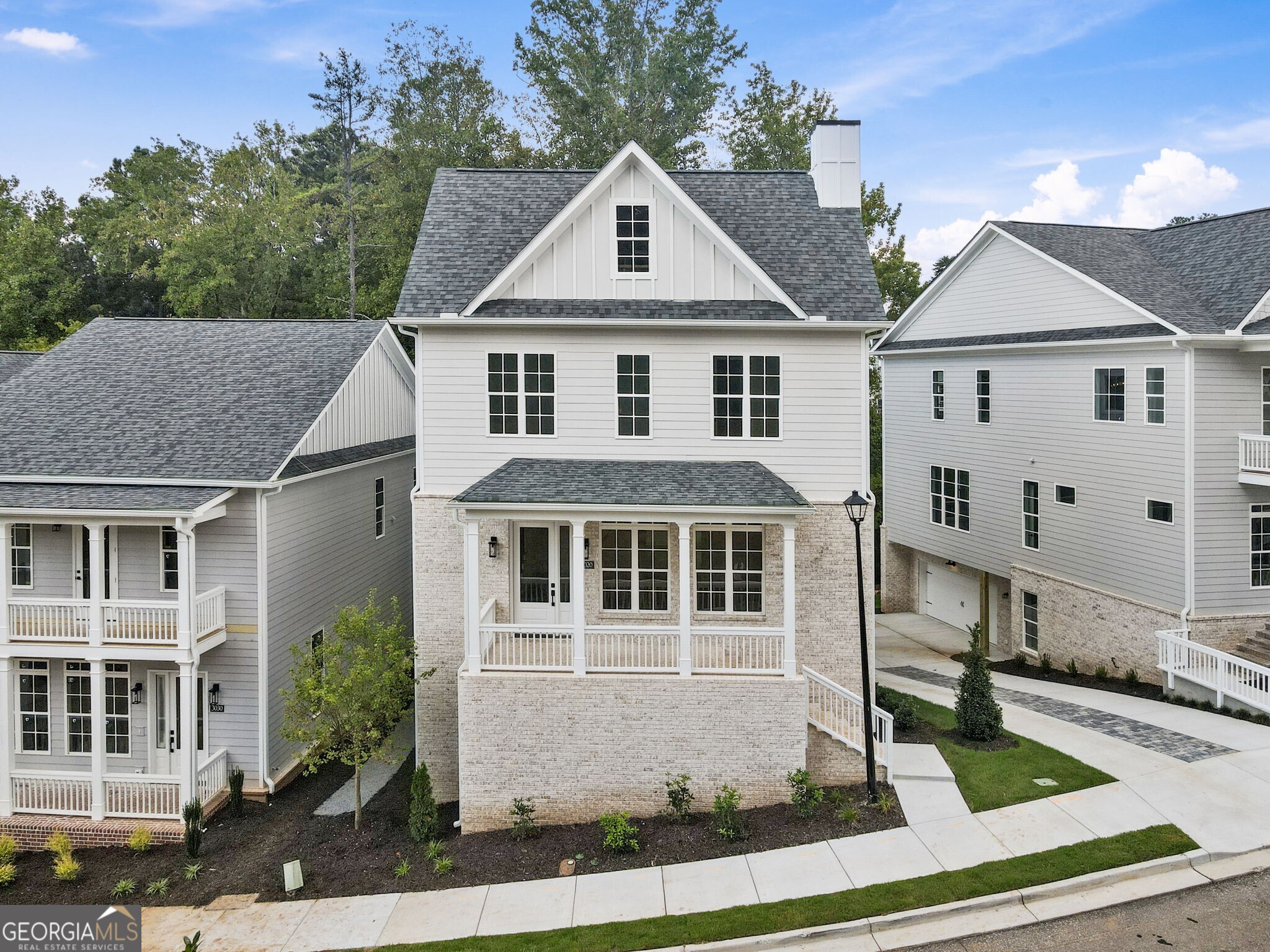 Discover Parkside Roswell - a premier new construction community directly across from East Roswell Park, where 40 acres of walking trails, tennis courts, sports fields, a dog park, playgrounds, and frisbee golf invite endless outdoor recreation. Perfectly positioned near Johns Creek, Peachtree Corners, and the Chattahoochee River, Parkside offers unmatched convenience to top shopping, dining, and GA-400. This brand-new single-family home is thoughtfully designed for today's lifestyle with soaring 10' ceilings, wide-plank hardwood floors, and an open-concept floorplan that seamlessly connects the great room, gourmet kitchen, and dining area. The chef's kitchen impresses with custom shaker cabinetry, sleek quartz countertops, a 9' waterfall island, stainless steel appliances, and a walk-in pantry. A cozy fireplace with herringbone tile detailing anchors the living space, while your back deck overlooks wooded and private views extends the home's entertaining potential. Upstairs the luxurious primary suite features dual walk-in closets, a spa-inspired bath with quartz counter tops, a freestanding soaking tub, frameless glass shower, and a private covered balcony for quiet retreat. Two additional bedrooms, a shared bath, and a convenient laundry room complete this level. The terrace level with 12' ceilings provides incredible flexibility, offering a full bedroom with ensuite, a versatile bonus room ideal for a gym, office, or media space, plus a mudroom/drop zone off the two-car garage. Parkside Roswell blends beautiful design, everyday convenience, and outdoor living-an exceptional opportunity to own new construction in one of North Fulton's most sought-after locations.