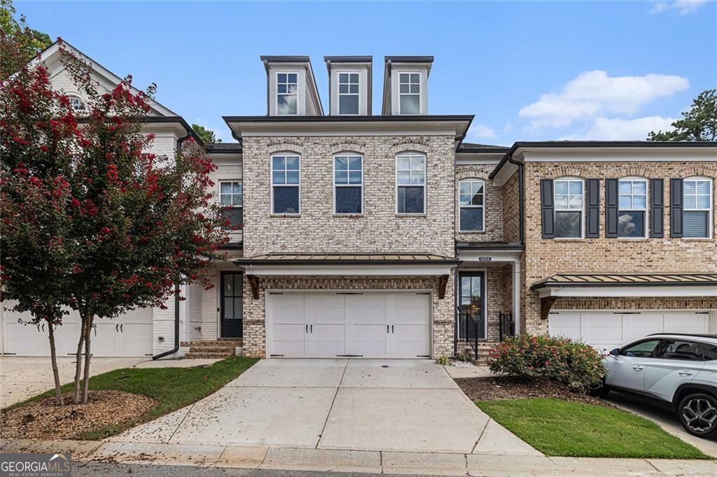 Stunning Farmhouse-Inspired Townhome! You'll approach through the gated entry to this immaculate, architecturally stunning community. Home features wide plank hardwood floors balanced with silvery-white living spaces including chef's kitchen w/ sleek quartz countertops, stainless appliances, subway tile, gas cooking w stainless vent, massive breakfast bar, island with sink, pendant lighting, large open dining, family room w/ batton board millwork and wall of windows overlooking the ultra private fenced backyard. Entertaining expands to covered patio, custom fencing lined by a canopy of trees. Owners suite w trey ceiling, double french doors to tile bath, massive spa shower, separate quartz vanities, two secondary bedrooms and bath with double sinks, carriage style 2 car garage with additional storage added by Seller. Imagine owning this stunning home in the best spot in this quiet neighborhood with walking path and pond, minutes to Roswell Area Park, Downtown Roswell, Crabapple, Alpharetta and Avalon. All this and more with Top Rated Schools.