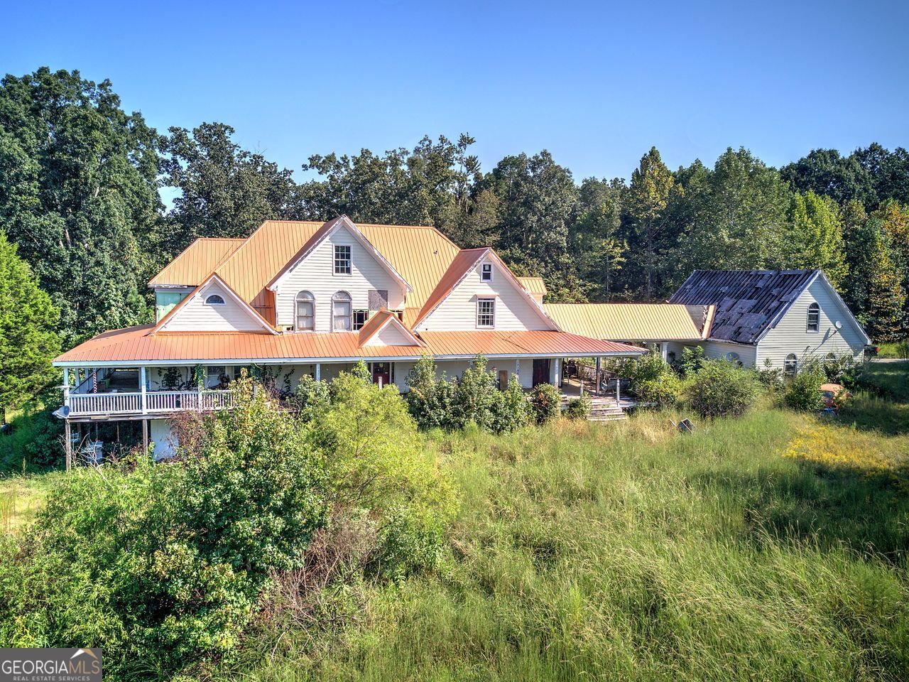Looking for a rehab property to put your own touches on?? The bones of this home are solid, spanning close to 4,000 square feet, and it sits right under 13 acres with a pond and mountain views. This would be a great generational estate property. Three-car detached garage with breezeway to the main home. Expansive wrap-around porch offering views from all sides. Partial basement on a Concrete foundation. This home has the potential of five bedrooms and five bathrooms; the possibilities are endless. Build a separate residence for your parents or children on the property. The property offers privacy and seclusion with trees and open land to garden or have livestock. The value lies in the land and house materials. Sellers are motivated and want to see your offer. Please reach out to your agent or call me directly to schedule your private showing-estate sale Sold AS IS.