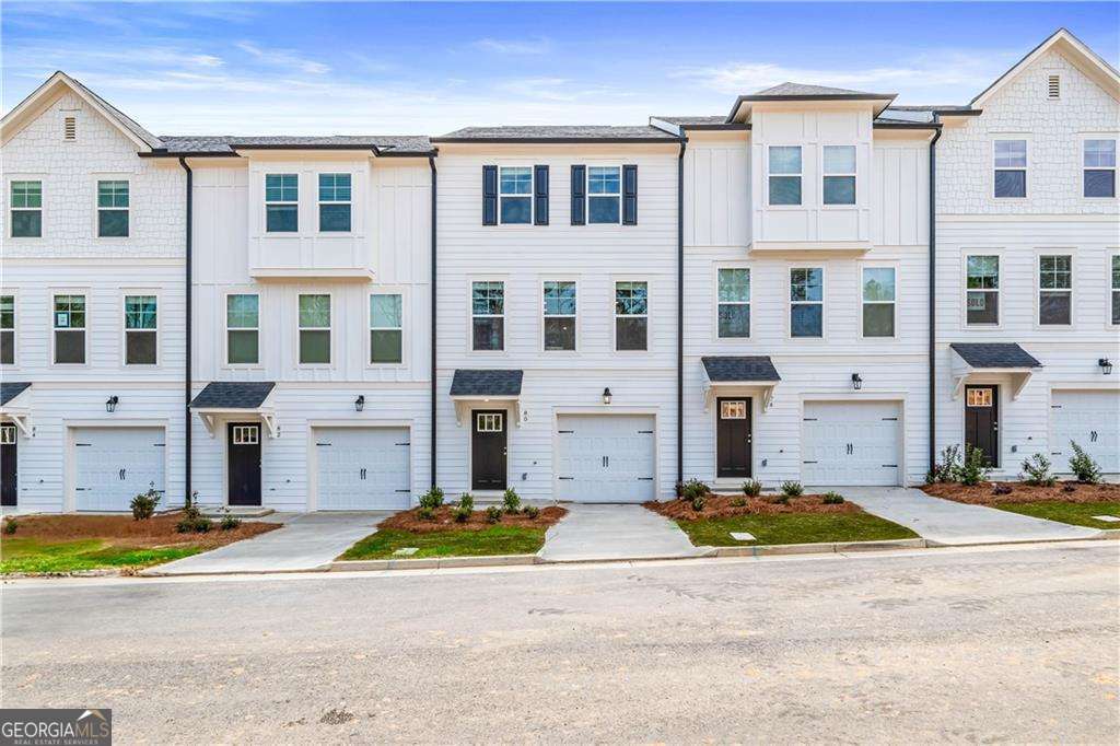 Discover this impressive three-story townhome featuring 3 bedrooms and 3.5 baths, plus a spacious game room perfect for entertaining. The ground level includes a large game room, a half bath, and access to a covered back patio. On the second level, enjoy a beautifully designed kitchen with ample cabinetry, a large island, Quartz countertops, a tile backsplash, and a full suite of stainless-steel appliances. The kitchen overlooks the breakfast and family rooms, making it ideal for gatherings, and there's a convenient powder room on this level. The third floor is your private retreat, with a roomy Owner's suite featuring tray ceilings, dual walk-in closets, and a luxurious spa-like bathroom with a double vanity. Two additional spacious bedrooms, pre-wired for ceiling fans, and a full bathroom are also on this level. The laundry area includes a washer and dryer. Additional features include a one-car garage with an opener, a one-car parking pad, and window screens and blinds throughout. Conveniently located just 2.5 miles from the airport, 9 minutes from downtown Atlanta, and 12 minutes from the College strip and Mercedes-Benz Stadium. You'll also be close to the future Aerotropolis and Airport City, with excellent access to major highways, Marta, and the Atlanta Beltline Eastside Trail. Monticello offers luxury townhome living with a low-maintenance lifestyle. *Photos are representative and may not reflect the actual townhome being built.* Please note: If the buyer is represented by a broker/agent, DRB REQUIRES the buyer's broker/agent to be present during the initial meeting with DRB's sales personnel to ensure proper representation.