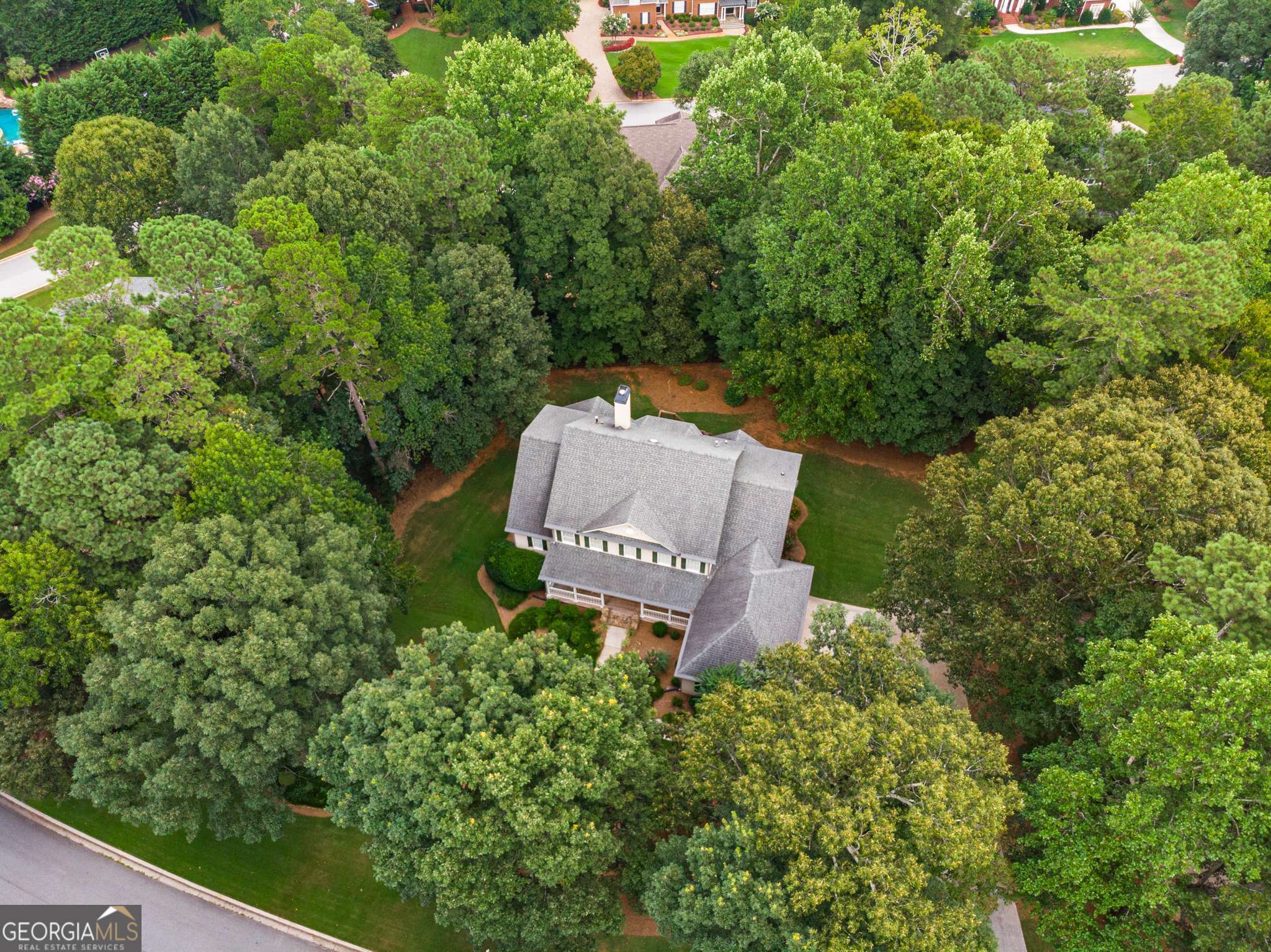There's a quiet confidence to this home-designed by noted architect Stephen Fuller-tucked into the heart of the Smoke Rise community, where the lots are large, the trees are mature, and the pace just feels a little more peaceful. At first glance, 2290 Spencers Way welcomes you with a timeless exterior and a deep, covered front porch that's more than just charming-it's where morning coffee becomes a ritual and evenings unwind with ease. Step inside and you'll sense how this home was intentionally crafted for both elegance and everyday living. The layout flows naturally, with formal rooms flanking the foyer that invite connection without sacrificing space. The two-story great room is bathed in light, centered around a classic fireplace and accented by a balcony above that gives the room its soaring feel. The adjoining kitchen and breakfast area overlook the deck and backyard, creating an ideal space for casual meals, weekend brunches, and late-night chats over a glass of wine. While the floor plan is expansive, it also offers the kind of practicality that's rare in homes of this size-like a private main-level primary suite and laundry, ideal for one-level living. Upstairs, there's room for everyone and everything: four bedrooms (one ensuite), two full bathrooms, walk-in closets, and a generously sized bedroom that easily flexes as a second family room, home office, or guest retreat. And then there's the basement-an unfinished expanse full of potential. Whether you envision a movie theater, in-law suite, home gym, or game room, the space is yours to shape. It's already framed with an ensuite, family room, and half bath in mind, making the groundwork for transformation that much easier. The three-car garage provides plenty of space for vehicles, hobbies, and storage, while a newer roof and updated gutters mean some of the heavy lifting has already been done. What remains is the opportunity to personalize and polish-your way. Located just minutes from Smoke Rise Country Club and the evolving charm of downtown Tucker, you're never far from tennis matches, golf games, good meals, or the quick commute into Atlanta. Plus, with nearby parks and several routes in and out of the city, adventure and convenience are always within reach. Homes like this-ones with good bones, soul, and space-don't come along every day. Especially not in Smoke Rise. If you've been searching for a home with character, land, and the freedom to make it your own, this may be the one worth moving on. Schedule your private tour today-and imagine what your next chapter could look like at 2290 Spencers Way.