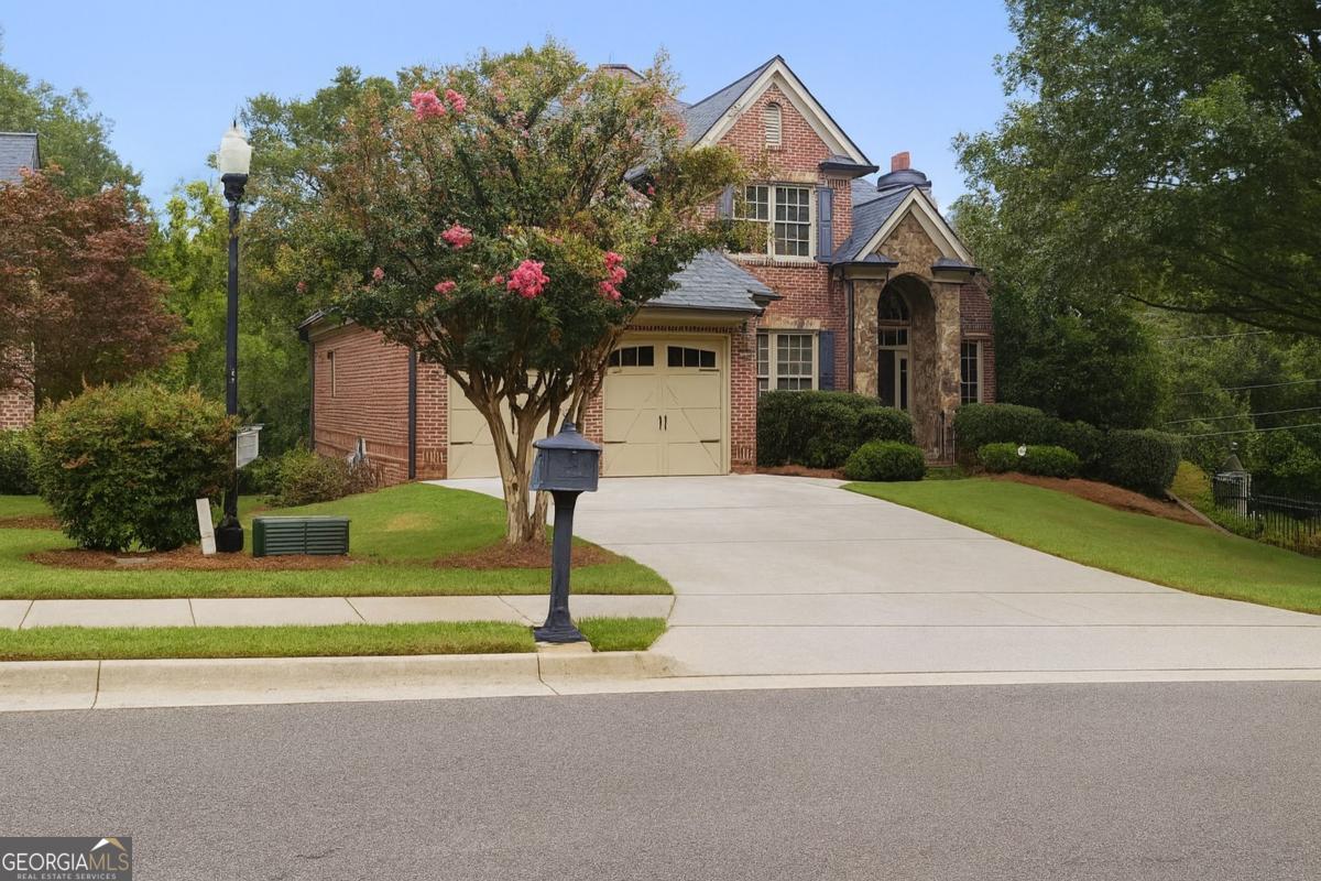Fall in love with this 4-side brick home on a full unfinished basement, tucked inside one of Gainesville's most desirable small executive neighborhoods - just minutes from downtown! From the moment you step into the vaulted two-story foyer, you'll be welcomed by rich hardwoods and timeless trim details. Just off the foyer, a beautiful home office makes working from home effortless, while a formal dining room sets the stage for gatherings and celebrations. The chef's kitchen with granite counters and custom cabinetry flows seamlessly into the living spaces. A main-level laundry room adds everyday convenience. Retreat to the oversized owner's suite on the main level, where you'll find a spa-inspired ensuite with a tile-surround shower, soaking tub, and dual vanities-your private escape at the end of the day. Upstairs, 4 generous secondary bedrooms with ensuite baths provide space for everyone. The full unfinished basement offers endless opportunities to expand-movie room, gym, or custom in law suite-the choice is yours. Outdoor living is unmatched with two screened-in porches! Enjoy Newer roof, unbeatable location, and true luxury living in the heart of Gainesville. Walk to the Downtown Square for dining, shopping, and community events, with easy access to Lake Lanier, Olympic Park, the University of North Georgia, I-985 and the hospital just 5 minutes away, this home blends luxury, lifestyle, and convenience like no other.