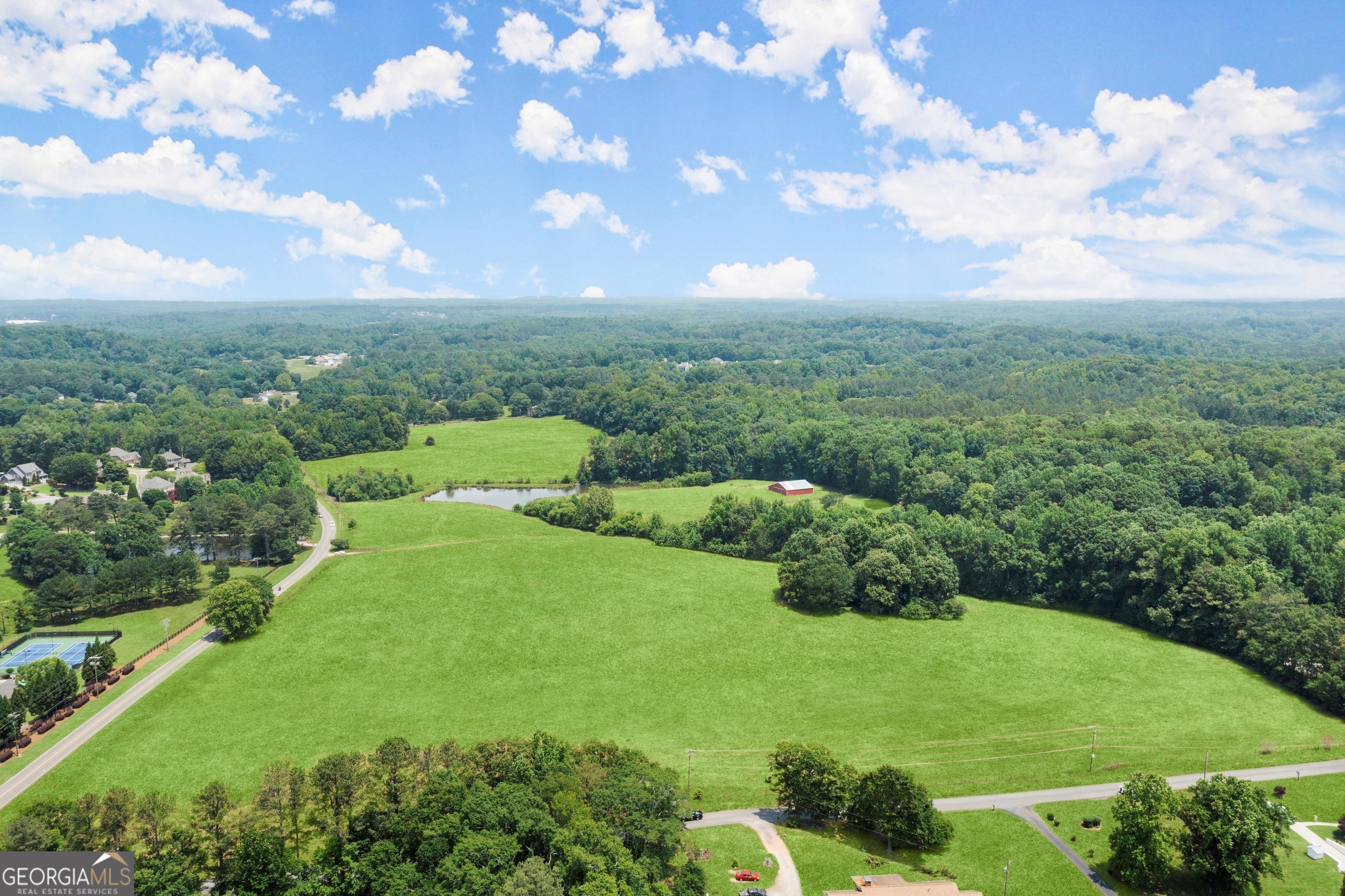 Welcome to 4324 Sugar Pike Rd, Canton, GA 30115! This magnificent property presents an exceptional opportunity for those seeking a picturesque equestrian estate. Sprawling across an expansive 59 acres of land, this property boasts various incredible features that will surely captivate any horse enthusiast. Nestled amidst beautiful rolling hills, the landscape of this property is truly enchanting. Immerse yourself in the tranquility of the surroundings as you embrace the breathtaking views that stretch as far as the eye can see. The property is dotted with active hay pastures, providing ample space for grazing and recreation. Whether you're a seasoned horse breeder or simply a horse lover, this estate is perfect for fulfilling your equestrian dreams. A standout feature of this property is its barn, which offers a multitude of possibilities. The barn boasts 5 exterior horse stalls and an open interior that can be customized however you desire. Imagine spending your days tending to your magnificent horses in this idyllic setting. Additionally, a serene pond adds to the charm of this estate. Picture yourself enjoying leisurely afternoons by the water's edge, taking in the peaceful ambiance that only nature can provide. The pond is not only a picturesque feature but also serves as a valuable water source for your horses and other animals on the property. The location of this property is equally desirable. Situated in Canton, GA, you'll have convenient access to nearby amenities, ensuring that your daily needs are just a short drive away. Furthermore, the area boasts a thriving equestrian community, offering opportunities for equestrian events, competitions, and socializing with other horse enthusiasts. Priced at $4,750,000, this property offers incredible value for anyone looking to turn their equestrian dreams into a reality. Bring your horses and envision building your dream equestrian facility on this expansive acreage. The possibilities are endless, and the canvas is blank, ready for you to create the equestrian paradise you've always dreamed of. Don't miss out on this remarkable opportunity. Schedule your private viewing today and let your imagination run wild as you envision the life you could lead on this extraordinary property at 4324 Sugar Pike Rd, Canton, GA 30115.
