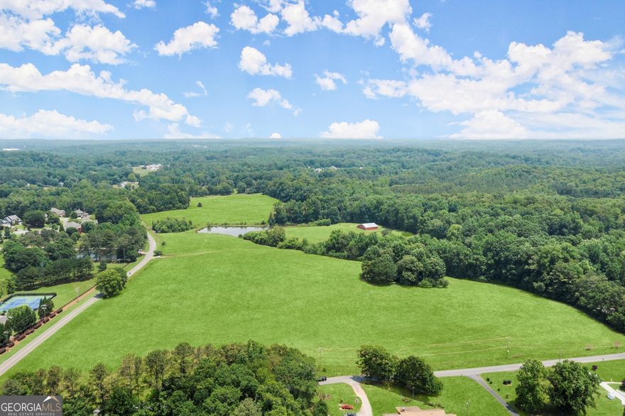 Welcome to 4324 Sugar Pike Rd, Canton, GA 30115! This magnificent property presents an exceptional opportunity for those seeking a picturesque equestrian estate. Sprawling across an expansive 59 acres of land, this property boasts various incredible features that will surely captivate any horse enthusiast. Nestled amidst beautiful rolling hills, the landscape of this property is truly enchanting. Immerse yourself in the tranquility of the surroundings as you embrace the breathtaking views that stretch as far as the eye can see. The property is dotted with active hay pastures, providing ample space for grazing and recreation. Whether you're a seasoned horse breeder or simply a horse lover, this estate is perfect for fulfilling your equestrian dreams. A standout feature of this property is its barn, which offers a multitude of possibilities. The barn boasts 5 exterior horse stalls and an open interior that can be customized however you desire. Imagine spending your days tending to your magnificent horses in this idyllic setting. Additionally, a serene pond adds to the charm of this estate. Picture yourself enjoying leisurely afternoons by the water's edge, taking in the peaceful ambiance that only nature can provide. The pond is not only a picturesque feature but also serves as a valuable water source for your horses and other animals on the property. The location of this property is equally desirable. Situated in Canton, GA, you'll have convenient access to nearby amenities, ensuring that your daily needs are just a short drive away. Furthermore, the area boasts a thriving equestrian community, offering opportunities for equestrian events, competitions, and socializing with other horse enthusiasts. Priced at $4,750,000, this property offers incredible value for anyone looking to turn their equestrian dreams into a reality. Bring your horses and envision building your dream equestrian facility on this expansive acreage. The possibilities are endless, and the canvas is blank, ready for you to create the equestrian paradise you've always dreamed of. Don't miss out on this remarkable opportunity. Schedule your private viewing today and let your imagination run wild as you envision the life you could lead on this extraordinary property at 4324 Sugar Pike Rd, Canton, GA 30115.