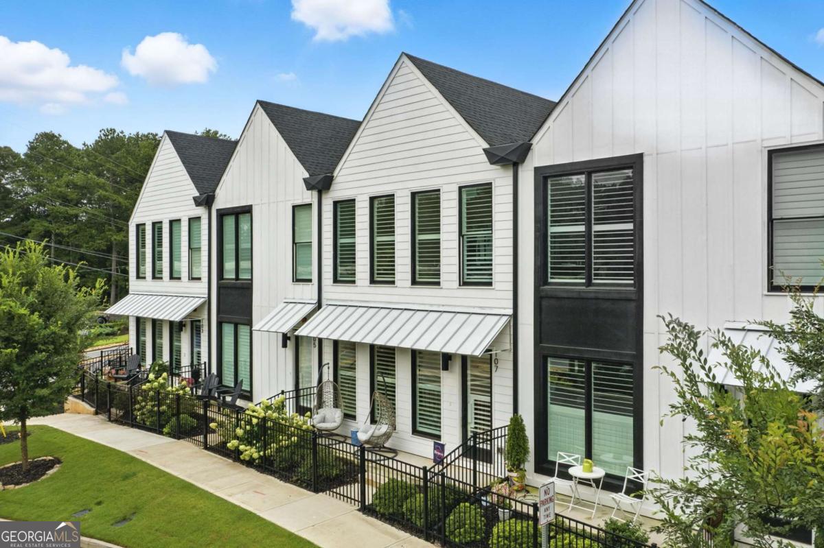 Enjoy living your best life in Downtown Woodstock! This townhome is walking distance to all that Downtown has to offer - restaurants, entertainment, breweries, parks, shopping, concerts and more! This home was just built in 2022 and is in immaculate condition. It features the owner's suite on the main level, quartz countertops throughout, an upgraded elevation that offers tons of windows to bring in natural light, plantation shutters, durable LVP flooring, upgraded plumbing fixtures, 8' doors throughout the main level, a large walk-in shower, a spacious walk-in closet, a large bonus room + two bedrooms and a bathroom upstairs, space in the basement that could be finished for more square footage and so much more. The location also offers quick and easy access to The Outlet Shoppes at Atlanta, Towne Lake, healthcare offices, grocery shopping and I-575.