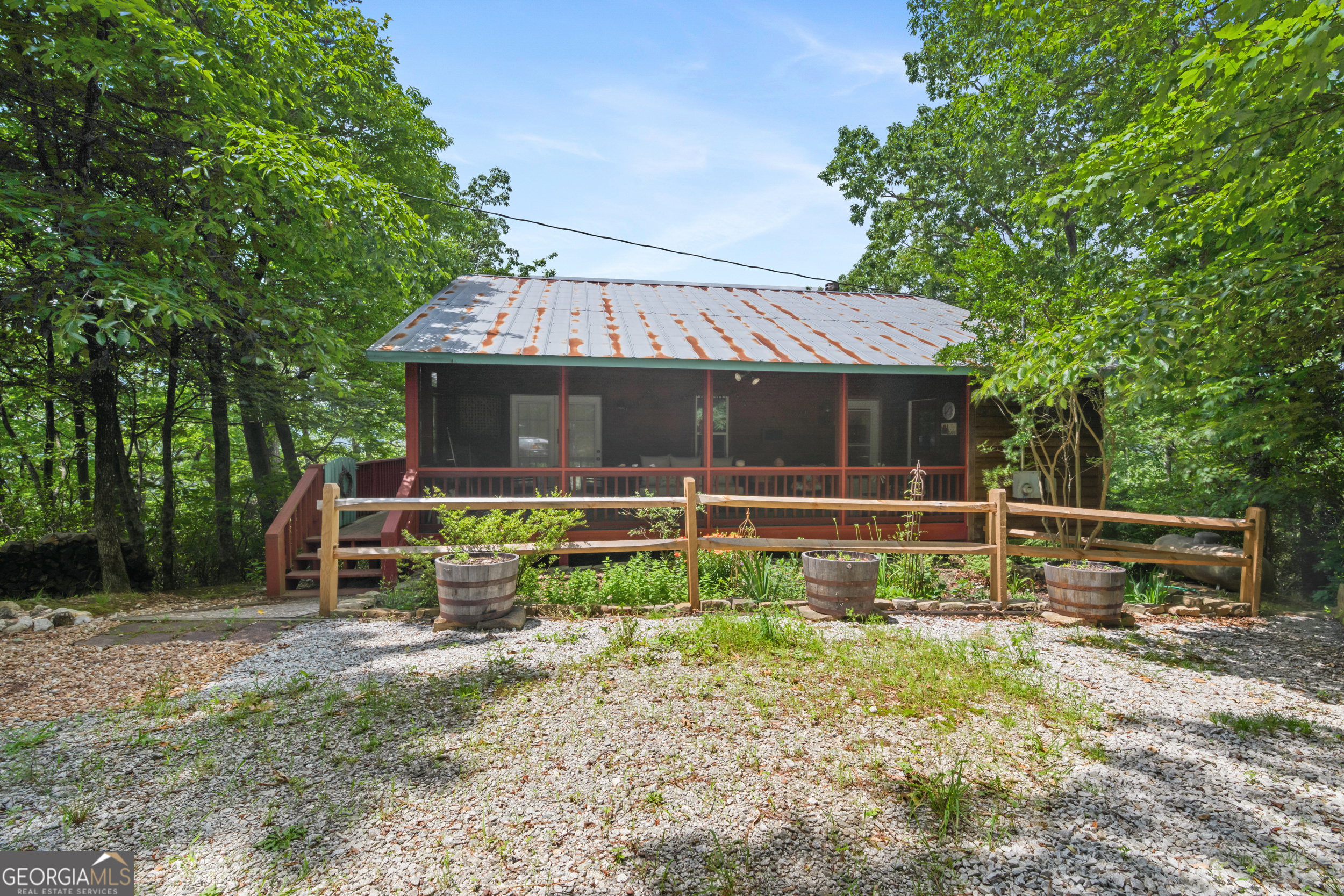 Escape to your own private mountain sanctuary with this incredible cabin offering long-range views, total end-of-road privacy, and direct access to U.S. Forestry Service land. Tucked away in a coveted location just 10 minutes from downtown Clayton, this beautifully maintained retreat combines rustic charm with modern comforts. Wake up to awe-inspiring views of Pickens Nose and the surrounding Blue Ridge landscape-visible from nearly every room and the expansive wraparound deck. Whether you're sipping coffee at sunrise or entertaining guests under the stars, this home offers the perfect setting for year-round enjoyment. Inside, the warm and inviting family room showcases soaring ceilings, rich wood walls, and a cozy wood-burning fireplace-perfect for chilly mountain evenings. The recently updated kitchen features sleek new appliances and blends beautifully with the home's timeless wood finishes and hardwood flooring. The main-level primary suite includes an updated bath, offering comfort and convenience all on one level. Whether you're searching for a weekend getaway, full-time residence, or a short-term rental investment, this cabin delivers on all fronts. Don't miss your chance to own a true mountain gem in one of North Georgia's most desirable areas! Home is being sold furnished.