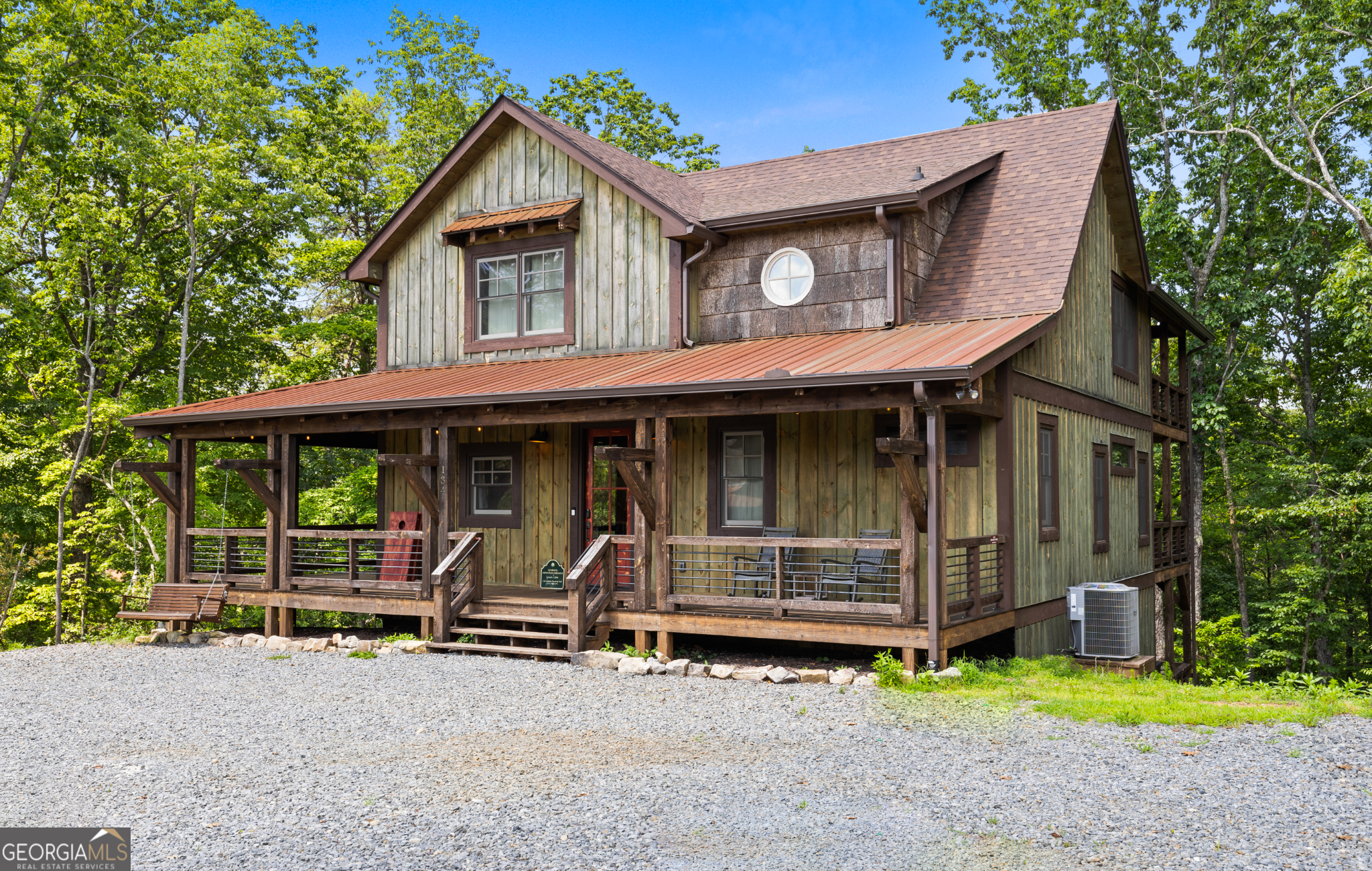 Welcome to your mountain sanctuary in the heart of Blue Ridge! This luxurious, custom-built cabin by renowned builder Marc Nicholson offers stunning mountain views that can be seen from the front porches. Nestled in the tranquil woods of Cohutta Overlook, this cabin provides a peaceful retreat with beautiful natural surroundings. This cabin provides an ideal blend of rustic charm and modern elegance. Featuring 3 spacious bedrooms, 3.5 baths, and an open-concept living space with soaring ceilings, exposed beams, and a stunning stone fireplace, this retreat is designed for comfort and style. The gourmet kitchen boasts granite countertops, stainless steel appliances, and a large island perfect for entertaining. Step outside onto expansive decks, complete with a wood-burning fireplace, hot tub, and swinging beds to relax and enjoy the serene beauty of nature. The fully finished terrace level includes a cozy den, game room, wet bar, and walk-out access to additional outdoor living space. Tucked within a private mountain community and just minutes from downtown Blue Ridge, Lake Blue Ridge, and endless hiking trails, this property is ideal as a full-time residence, second home, or high-demand short-term rental.