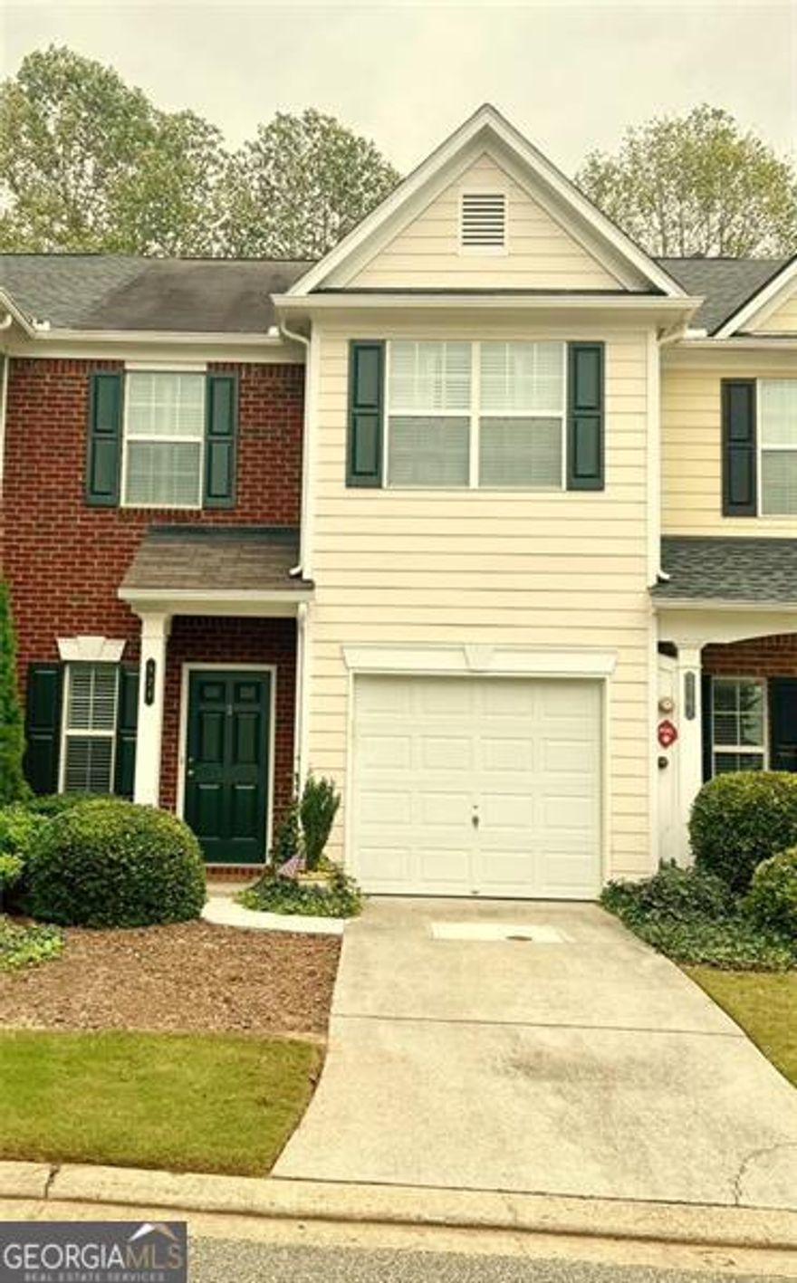 Move-in ready townhome featuring an open-concept main floor with high ceilings, a welcoming two-story foyer, and a single-car garage. The updated kitchen includes plenty of cabinet space and a large pantry-perfect for everyday living and entertaining.  Upstairs offers two spacious bedrooms, each with its own private bathroom and generous closet space. The primary suite includes an updated bath, and the laundry room with full size hookups is conveniently located upstairs for easy access.  Enjoy peaceful wooded views from your private back patio, ideally situated at the end of the street within the community. Rent includes access to all amenities-pool, tennis, lawn care, and trash service. Just one mile from I-575 and The Outlet Shoppes at Atlanta, and minutes from downtown Woodstock's restaurants, parks, and shopping.