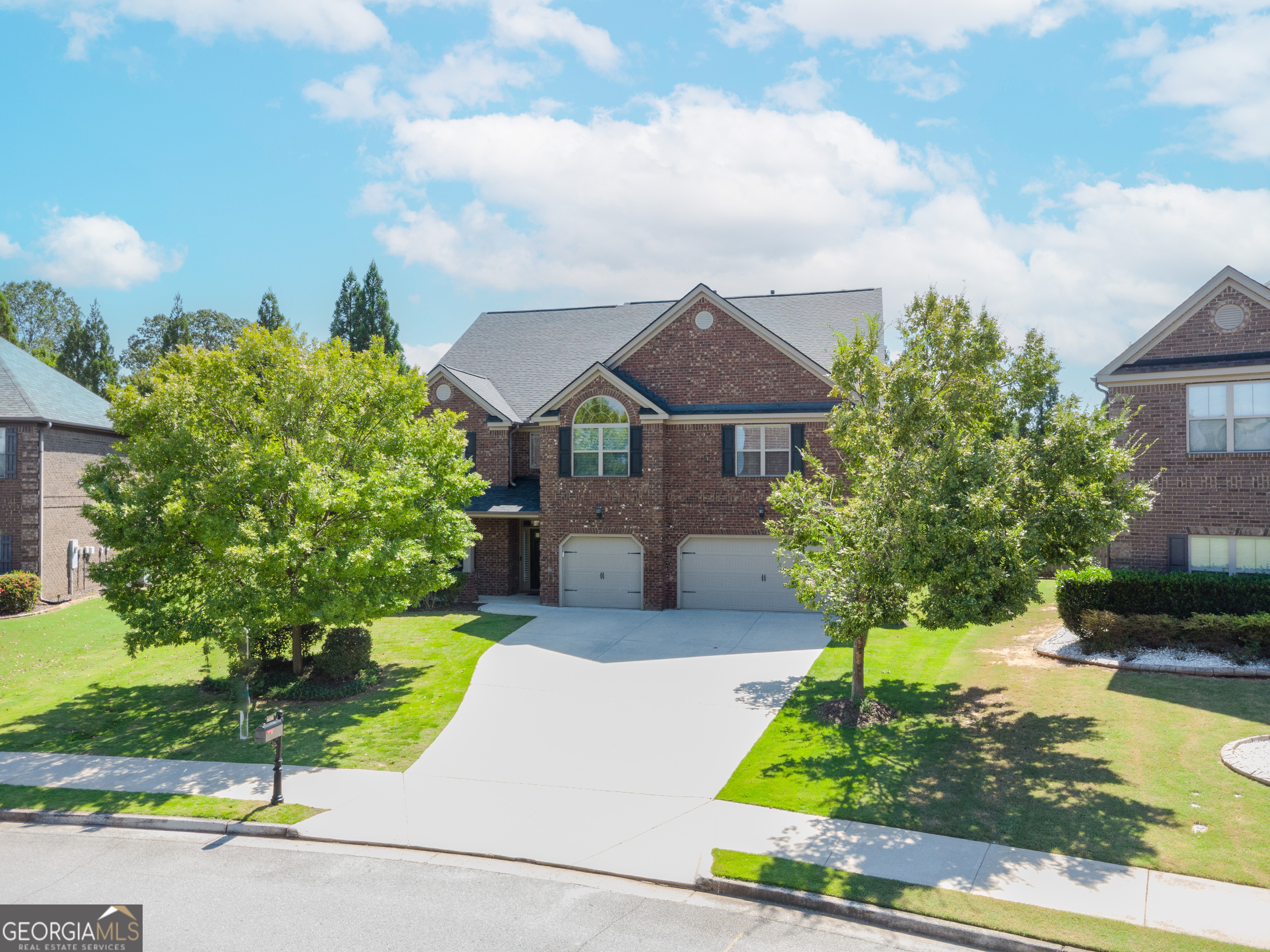 Buford City Schools (#1 in Nation per Niche.com) | Hall Co. Taxes | 7BR/5BA | 5,676 sq ft | $799,000 ($141/sf) | Wynfield. Spacious 7BR/5BA home designed for flexible living, featuring a newly added main-level in-law suite with a zero-entry tiled shower and built- in surround sound-perfect for guests, aging parents, or multi-generational families. One of the largest homes in Wynfield, this 3-story layout offers space, versatility, and exceptional value. Also on the main level: a two-story foyer with well-maintained original hardwood floors, a private office with French doors, and a gourmet kitchen with granite islands, double ovens, gas cooktop, oversized walk-in pantry, premium new dishwasher, and reverse osmosis water filtration; the living room has a coffered ceiling and stacked stone gas fireplace. Upstairs: owner's suite with trey ceiling, sitting area, dual vanities, soaking tub, and massive walk-in closet; Jack-and-Jill suite; additional ensuite; and an open loft ideal for a playroom, homework area, or casual lounge. The third floor offers a step-up media room with surround sound equipment included, two bedrooms, and a full bath. Newer roof (5-6 yrs), security system with cameras/Ring, keyless entry, 3-car garage, oversized driveway, covered patio, fenced backyard with French drain. $33/mo HOA. Minutes to Lake Lanier, Cherokee Bluff Park, Publix, Target, and Hwy 985.