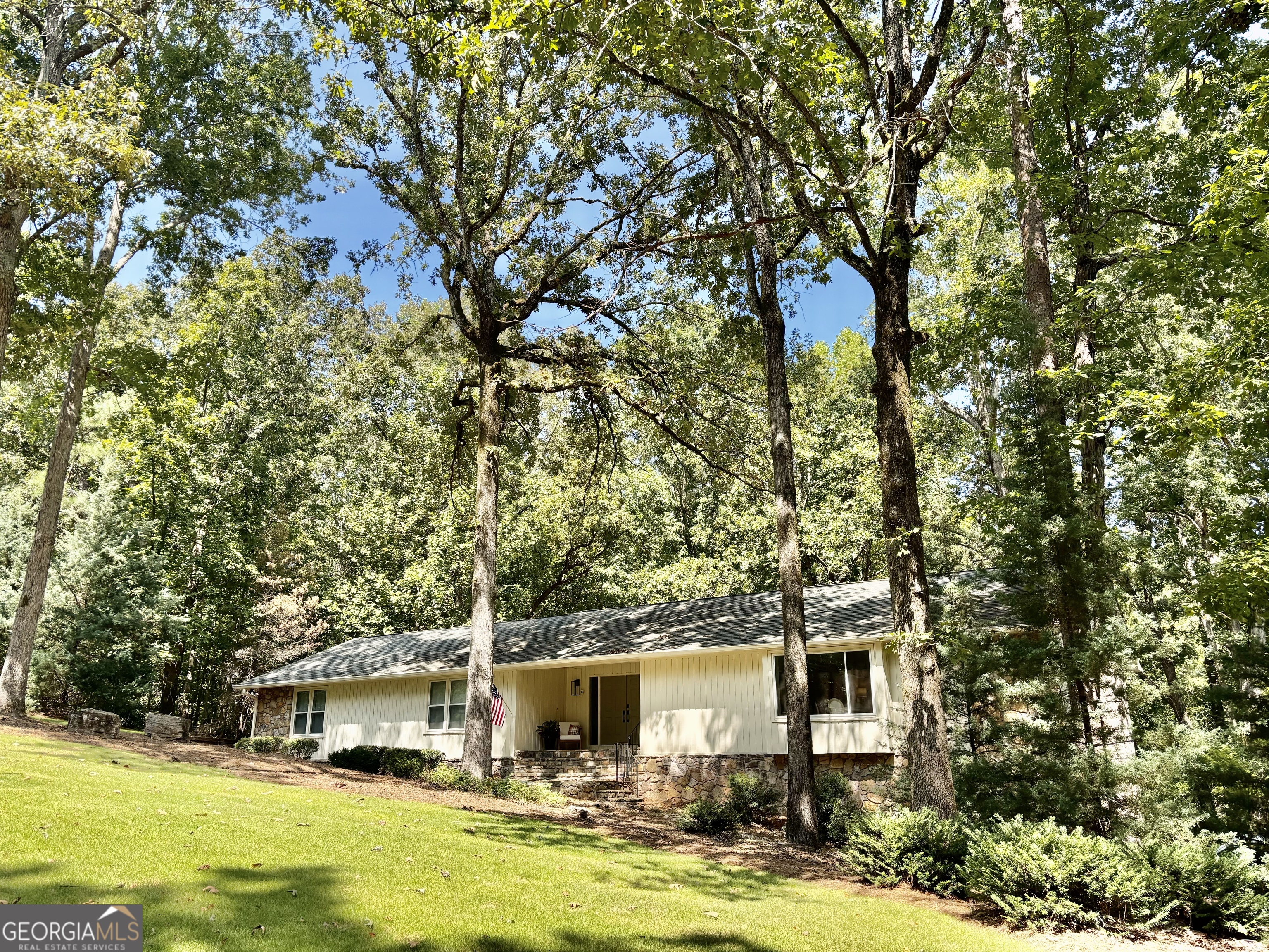 Welcome to 2 Kensington Rd SW, a rare opportunity to own a renovated ranch over a finished basement in the prestigious River Ridge community-one of Rome's most desirable neighborhoods. Known for its walkability, tree-lined streets, and proximity to Lawrence Preserve country club, River Ridge offers the perfect blend of privacy, beauty, and convenience. This stunning 4-bedroom, 3-bathroom home has been thoughtfully updated with premium finishes throughout. The completely remodeled kitchen is a chef's dream, featuring custom cabinetry with soft-close drawers, a professional-grade gas range, quartz countertops, a massive 12-foot island, and stainless appliances. Gorgeous new hardwood floors flow through the common areas, complementing the fresh interior and exterior paint. The hall bathroom has been completely renovated, while the spacious primary suite includes an updated ensuite bath with stylish finishes. Enjoy energy efficiency and comfort year-round with all new windows and brand-new HVAC system. Step into the inviting sunroom or out onto one of the two expansive decks to take in the beauty of the landscape. Downstairs, the finished basement offers flexibility with a large open common area, a bedroom, full bathroom, and abundant storage-including large walk-in closets and a flex space. Outside, relax by your private creek-side stone patio, an ideal space for entertaining or unwinding in nature. The oversized garage includes a dedicated storage room and convenient exterior access. With over 1.3 acres of serene, usable land and an ideal layout for modern living, this property combines timeless charm with today's most desired updates. OFFERING $5,000 toward closing costs, Buy Down or whatever you choose! Call Cindy today for your tour! 706-409-1793 24 hour notice preferred.