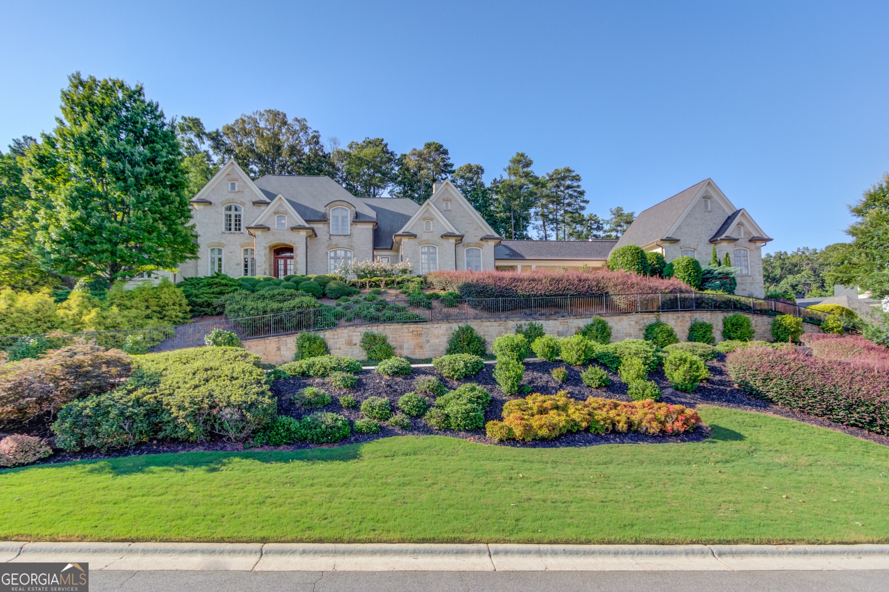 Discover a serene blend of luxury and harmony in this beautifully designed Feng Shui home located in the prestigious gated community of The River Club. This exceptional estate offers 7 spacious bedrooms, brick and stone exterior, and a wealth of amenities designed for ultimate comfort and elegance.  Thoughtfully crafted to promote balance, positive energy, and a sense of well-being throughout the home. Timeless brick and stone facade exuding charm and sophistication, paired with an expansive 8-car garage for convenience. Perfect for family gatherings and entertaining, the kitchen flows seamlessly into the keeping room and breakfast room, with ample space for casual dining. The luxurious main-level owner's suite includes two vanities, a whirlpool tub, and a steam shower, creating a spa-like experience in your own home.Enjoy leisure at home with a wine cellar, theater room, and billiards room, perfect for hosting guests or unwinding in style. A screened porch with tranquil space to enjoy the outdoors, ideal for relaxing in privacy with year-round comfort. Work from home in the beautifully appointed office featuring a beamed ceiling, adding warmth and elegance to the workspace. This remarkable home combines the best of refined living with thoughtful design elements, all in the exclusive golf community of The River Club. Schedule your private tour today and experience a lifestyle of luxury, balance, and tranquility!