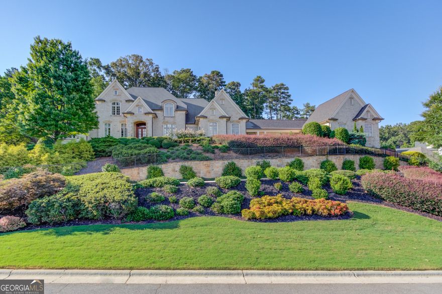 Discover a serene blend of luxury and harmony in this beautifully designed Feng Shui home located in the prestigious gated community of The River Club. This exceptional estate offers 7 spacious bedrooms, brick and stone exterior, and a wealth of amenities designed for ultimate comfort and elegance.  Thoughtfully crafted to promote balance, positive energy, and a sense of well-being throughout the home. Timeless brick and stone facade exuding charm and sophistication, paired with an expansive 8-car garage for convenience. Perfect for family gatherings and entertaining, the kitchen flows seamlessly into the keeping room and breakfast room, with ample space for casual dining. The luxurious main-level owner's suite includes two vanities, a whirlpool tub, and a steam shower, creating a spa-like experience in your own home.Enjoy leisure at home with a wine cellar, theater room, and billiards room, perfect for hosting guests or unwinding in style. A screened porch with tranquil space to enjoy the outdoors, ideal for relaxing in privacy with year-round comfort. Work from home in the beautifully appointed office featuring a beamed ceiling, adding warmth and elegance to the workspace. This remarkable home combines the best of refined living with thoughtful design elements, all in the exclusive golf community of The River Club. Schedule your private tour today and experience a lifestyle of luxury, balance, and tranquility!