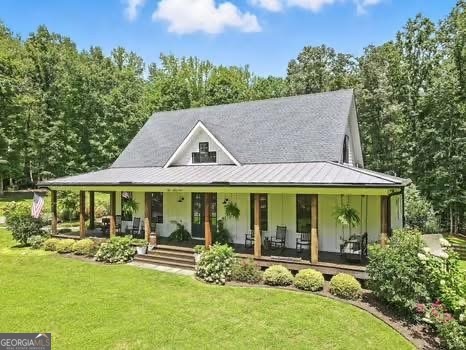 Welcome to your dream estate! Selling with 2 HOMES ON THE PROPERTY AND TOTAL OF 7.68 ACRES! Perfectly positioned in one of Cherokee County's most desirable locations and zoned for the award-winning Creekview High School, this 2017 custom-built farmhouse is a rare find. Just minutes to Milton, Alpharetta, and Ball Ground. Main home is Sitting on 5.48 acres of pristine, landscaped land, this 4-bedroom, 3-bathroom estate is a peaceful retreat with modern amenities, timeless charm, and flexible living space that fits your lifestyle today-and grows with you tomorrow. This home features a thoughtfully designed open-concept layout with expansive great room, sunroom, and bonus room, inviting spaces with vintage distressed hardwood floors throughout the main level. First-floor owner's suite featuring a spa-like bath, walk-in shower, custom vanity, and spacious walk-in closet, Gourmet kitchen with stone countertops, high-end appliances, and ample cabinetry-perfect for the home chef! Seamless flow between the living, dining, and kitchen areas. Beautiful sunroom off the kitchen with a wood burning fireplace. This home is ideal for gatherings and entertaining! Upstairs Living & Flex Space: This unique home offers two separate upstairs entrances for maximum versatility: there is a Private suite above the garage-ideal for guests, a home office, or playroom and a Second staircase leads to two oversized bedrooms, a full bath, and a bonus room perfect for a game room or additional office space! Downstairs there is 2,000+ sq ft partially finished basement with endless possibilities: in-law suite, gym, theater, bar/kitchen-a blank canvas for your vision! Some additional features of the property include Control4 smart home system with integrated Sonos speakers throughout, Irrigation system in front and side yards for easy maintenance and a 2 stall barn! This property is a true gem and has its own peace with this outdoor oasis, wrap-around porch for morning coffee, evening wine, and everyday relaxing. The second home is brick farmhouse-style home with 3 bedrooms and 2 bath on the property! Perfect for multi-generational living. This home features its own 2.2 acre lot with garden area and fenced back yard. Note: This second home will not be shown without proof of funds or pre-approval for both properties. Location Highlights: * Minutes to top-rated schools, shopping, dining, and major highways * Ideal for those seeking space, privacy, and convenience in one incredible package! Don't Miss This Rare Opportunity! Whether you're looking for your forever home, a multi-generational property, or a peaceful luxury escape close to it all, this stunning farmhouse offers more than just a home-it's a lifestyle