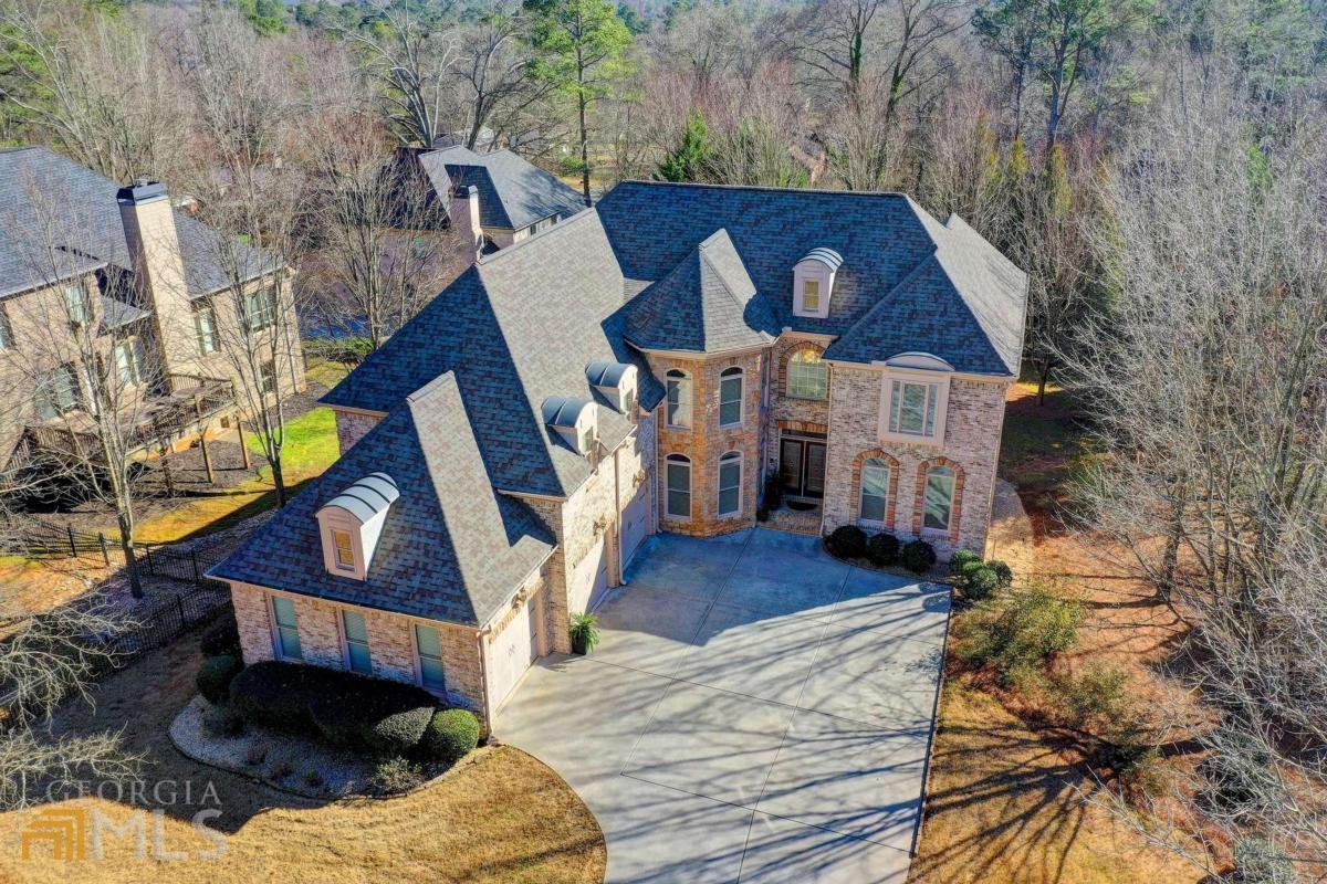 Have you been looking for a fabulous new lifestyle? If you want a beautiful home, large yard, and an amazing ROSWELL location, THIS IS YOUR HOME! Imagine taking a short afternoon walk or a golf cart ride to Canton Street in Downtown Roswell, enjoying the shops and restaurants, then heading home to relax on your back deck. This 4-sided brick estate home features a 3-car garage, hardwood floors, a dramatic iron staircase, two-story great room, large home office, guest room on main with full en suite bath, and many elegant details. The open kitchen is perfect for the gourmet chef with its stained cabinets, granite countertops, walk-in pantry, double oven, and gas cooktop. After cooking an elegant meal, serve guests in the large formal dining room. The home's grand Master Suite features high ceilings with a pretty sitting room, ample closet space, and spa bath with an oversized frameless shower! You will have the perfect escape after a long day. There is also a small bedroom with bath, adjacent to the master for a nursery or a secondary home office. Across the catwalk, you will find two large secondary bedrooms sharing a Jack and Jill bathroom. Other home features include a secondary living room off of the kitchen and breakfast area, two fireplaces, built-ins, powder and laundry rooms on the main, covered patio, and neutral paint throughout. Close to Roswell Area Park, Historic Roswell, Shopping, and Dining. Minutes to I-400. Great Roswell Schools!