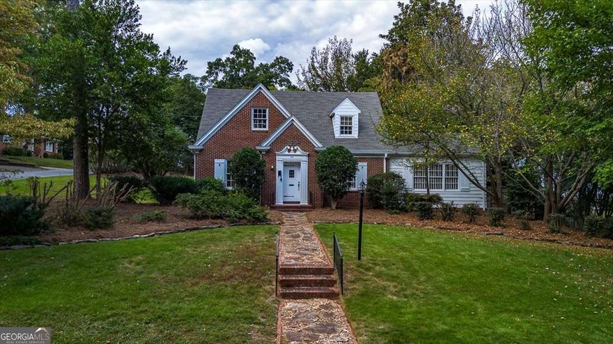 Located in the heart of Athens' most coveted neighborhood, this distinguished 1940s residence offers timeless charm and exceptional versatility on a beautifully manicured corner lot. Just moments from the University of Georgia and the vibrant Five Points district, the property blends historic character with modern lifestyle amenities in an unparalleled setting.    The main residence features four spacious bedrooms and two and a half baths across two thoughtfully designed levels. Rich hardwood floors, classic architectural details, and abundant natural light create a warm and inviting ambiance throughout. Outdoor living is elevated with a private brick patio and an upper-level retreat complete with a firepit-perfect for entertaining or quiet evenings under the stars.    A rare addition to this estate is the accessory dwelling unit (ADU), offering a screened porch with sweeping views of the expansive grounds. Complete with its own living area, kitchen, bedroom, bath, and laundry, the ADU provides ideal accommodations for guests, extended family, or additional income.    Set within walking distance to tree-lined Milledge Avenue, boutique shopping, fine dining, and cultural attractions, this property presents a unique opportunity to own a legacy home in one of Athens' most desirable enclaves. With its blend of historic elegance and contemporary potential, this residence awaits the vision of its next discerning owner.