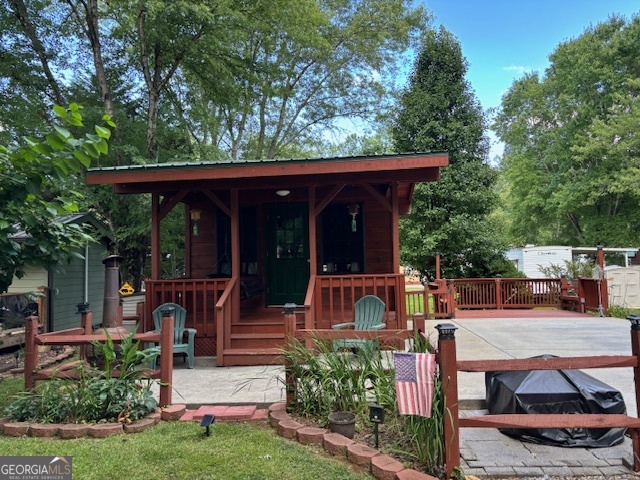 Looking for a little piece of Paradise to enjoy the N. Ga. Mountains, or just to park your RV? Come see this tiny studio style cabin! This stick built cabin has a 14-foot-long front porch with wicker swing to sit and enjoy the quiet serenity on this Fishtail Circle! The double wide driveway will fit a larger RV, has a large concrete pad, fresh gravel drive and can still fit 4 plus vehicles! There are nice shade trees surrounding the cabin and a grilling deck with bench seats perfect for entertaining. Inside are ceramic tile floors, wood walls, and a vaulted wood ceiling with a fan. All furnishings stay, such as the daybed couch with under storage, built-in end tables, table and four stools. a corner cabinet plus vaulted storage area. You'll create a lifetime of memories here, whether you're relaxing, fishing, or participating in the ongoing activities within Paradise, a gated community with fantastic amenities! Enjoy the pool, pavilion, clubhouse, and planned activities. The location is central to all the fun in nearby mountain towns and events, just minutes from Cleveland, Helen, Dahlonega, Clarkesville, and Blairsville. Shop, dine, fish, hike, and visit vineyards-the possibilities are endless! Please note that Paradise is a vacation resort community that does not allow full-time living. The listing agents are owners in Paradise, so feel free to call for a tour or more detailed information about Paradise and this property.