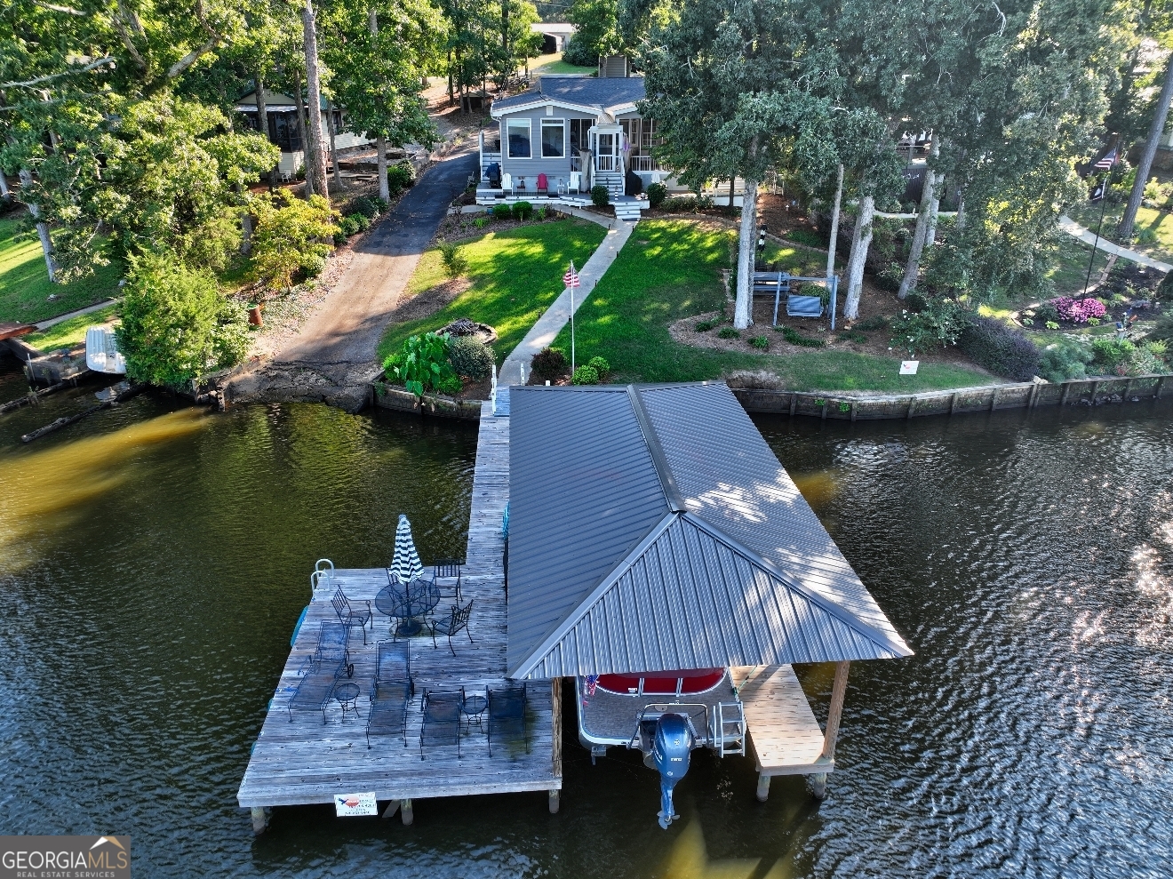 Unparalleled Lake Sinclair Lakefront Opportunity with inspirational views! Whether you value a place for entertaining, family gatherings, or are a retreat from the hustle and bustle of everyday life, now may be the time to create your own magic. This 3 bedroom 2 bath home features LVP flooring throughout, stainless steel appliances, granite countertops, and a screened in porch. This property features a single slip boathouse with deep water access, a stunning main lake view, a private boat ramp, and is centrally located between Eatonton and Milledgeville. This beautiful home is priced to sell and won't last long, so call today to schedule your showing.