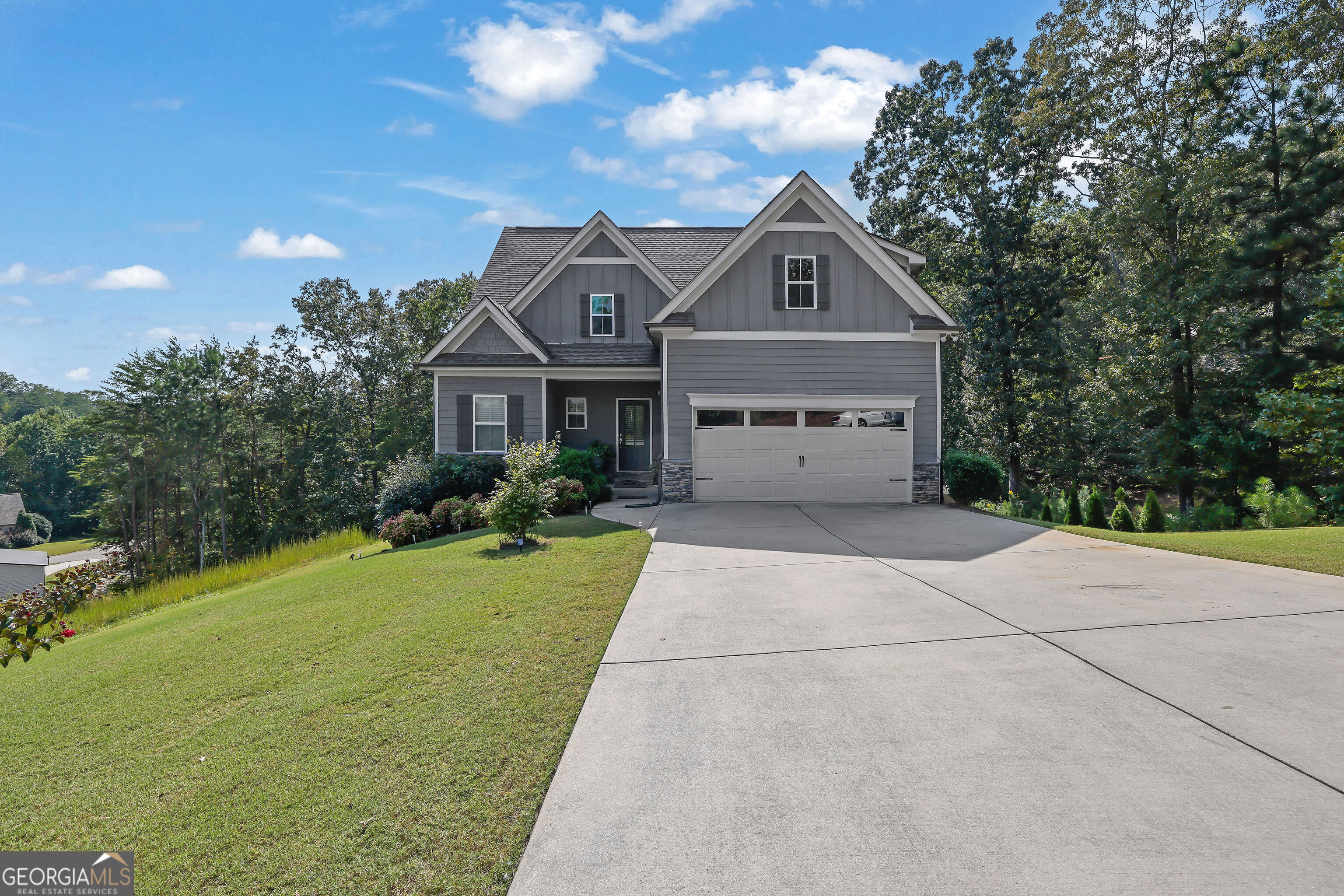 Come and see 99 Glen Oaks Dr in Dawsonville, a beautifully maintained 4-bedroom, 2.5-bath Traditional home with NO HOA. The open-concept layout is ideal for modern living, featuring a chef's kitchen with stainless steel appliances, granite countertops, a subway tile backsplash, and an oversized island overlooking the spacious living room with a stone fireplace. Enjoy the private, fully fenced backyard from your back deck, perfect for quiet mornings or evening gatherings. This home also includes a full basement offering incredible storage or expansion potential. Set on a .62-acre lot with lovely curb appeal, this home blends comfort, space, and functionality in a peaceful setting.