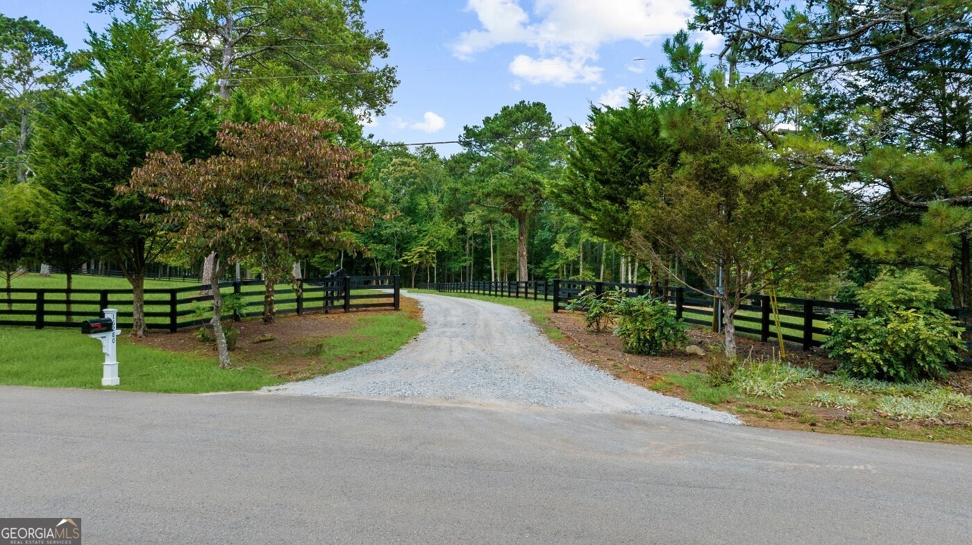 Discover a rare and highly coveted land opportunity in Cherokee county with Alpharetta address! This 10.65 acre tract offers lake frontage, spectacular views, gentle topography and pristine pastures for anyone looking to build a private estate, equestrian facility or hobby farm. There is an existing home on the property that can be renovated or torn down to build your dream custom home!