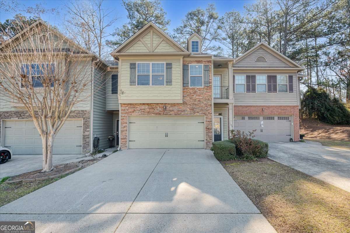Discover this beautiful craftsman-style townhome, featuring 3 bedrooms and 2.5 baths, now available from its second owner. The home showcases modern updates, including fresh paint, newer flooring, and a brand-new roof. Perfectly situated just minutes from Lake Allatoona, and within easy reach of local dining, shopping, and downtown Woodstock. The main level offers a spacious open-concept great room that includes a dining area with a cozy fireplace. The kitchen is a chef's delight, equipped with upgraded appliances, including a gas range/oven, built-in microwave, refrigerator, and a generous walk-in pantry. Upstairs, the primary suite serves as a tranquil retreat, featuring an en-suite bath, a large walk-in closet, dual vanities, a soaking tub, and a separate shower. Two additional well-sized bedrooms, a full bath, and a laundry room (with washer and dryer included) complete the upper level. Step outside to enjoy a private backyard with a patio, while the HOA manages exterior maintenance, trash collection, roofing, and more. This prime location offers access to award-winning schools and comes with no rental restrictions. Additionally, the Perpetual Financial Group is providing down payment assistance on this property, making it an opportunity not to be missed!