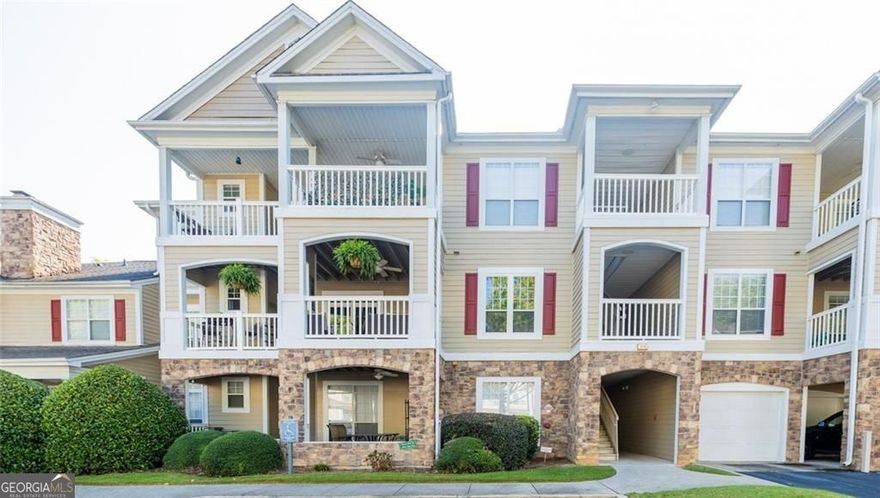 Step into effortless one-level living with serene pool views, modern updates, and a top-rated school district. This beautifully renovated 2BR/2BA first-floor condominium offers a tranquil setting overlooking the community pool from a charming covered patio. Inside, you'll find luxury vinyl flooring, fresh neutral paint, and a redesigned kitchen featuring new cabinetry, quartz-style countertops, subway tile backsplash, and stainless steel appliances-perfect for both everyday living and entertaining. The spacious bedrooms feature tray ceilings and walk-in closets, while the primary suite boasts an oversized tile shower and double vanity, and the secondary bath includes a stylish vanity and soaking tub. A full laundry room with washer and dryer adds extra convenience. A highly sought-after single-car garage conveys with the property and is just a short walk away in Building 400 on Pembrooke Circle.  Enjoy an amenity-rich lifestyle with access to a clubhouse, swimming pool, tennis and pickleball courts, fitness center, dog park, walking trails, and more. Ideally located minutes to Avalon and Halcyon with quick access to GA-400, this home is completely move-in ready, and all furnishings are negotiable, making it the perfect blend of comfort, convenience, and location. Schedule your private showing today.