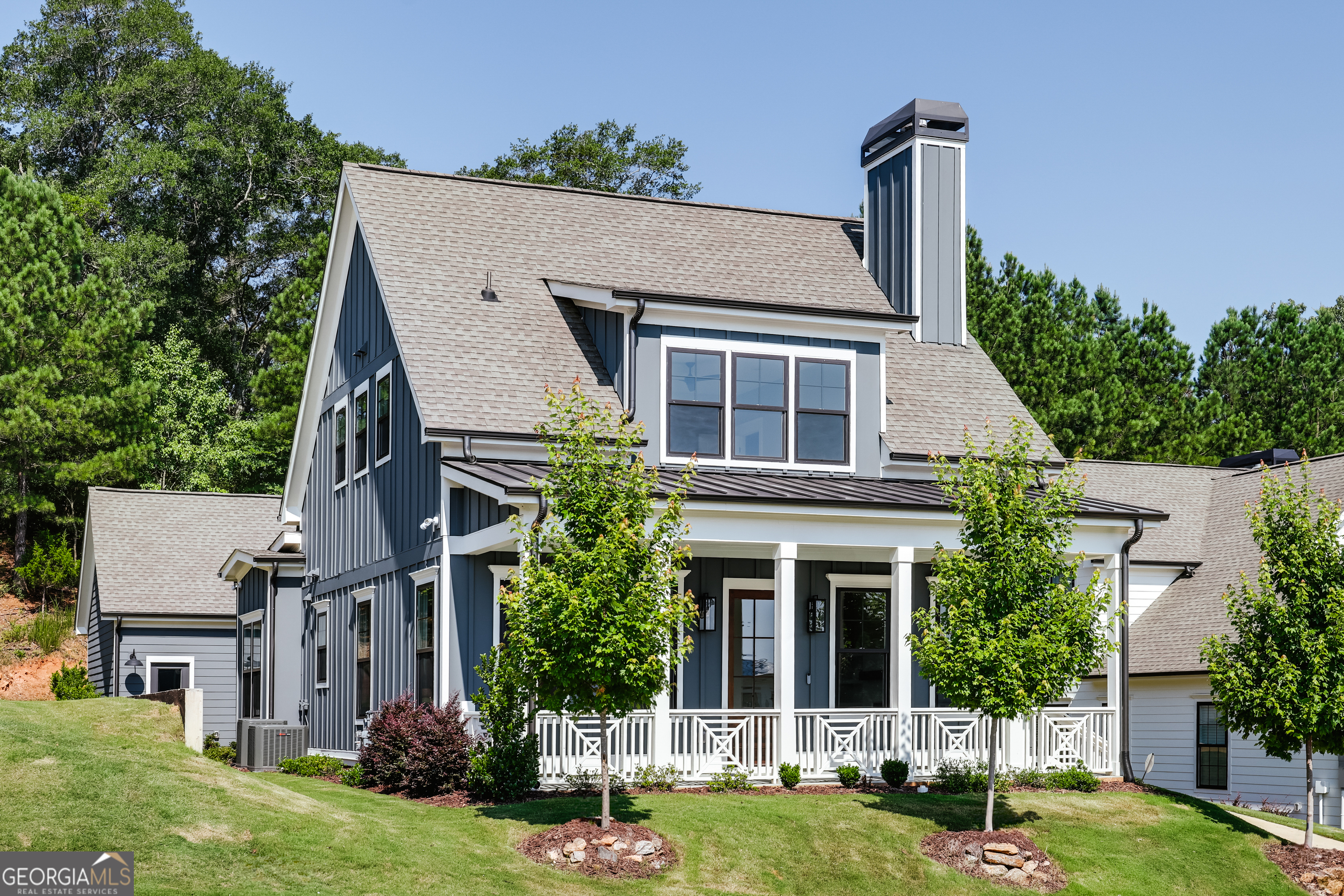 Discover the charm of the Goldenrod home, a delightful blend of a simple colonial-style cottage and contemporary design. The deep front porch is the perfect welcome and leads to an open floor plan that seamlessly combines style and functionality. The front living room is complete with a gas fireplace and custom-built in cabinets. The dining area is spacious and connects the gorgeous kitchen, creating the heart of the home. The unique separate bar area in the Goldenrod makes this home perfect for entertaining. The back hall leads to a private powder room, laundry and stairs to the second floor. The owners suite is located on the main level, complete with a large walk-in closet, soaker tub, frameless glass shower, and double vanity. Through the kitchen, a second back hall reveals a built-in buffet-style base cabinet and quartz countertop in a roomy sunroom. The hall also leads to the back door and two-car garage. Upstairs, two additional bedrooms and walk-in closets share a Jack-and-Jill bath, providing comfort and convenience. Like all Glenview homes, this residence comes with a two car garage, high-end appliance package, including a KitchenAid refrigerator, custom cabinetry, millwork, and the signature deep front porch. Wide-board hardwood floors add a touch of elegance to this enchanting Goldenrod home.