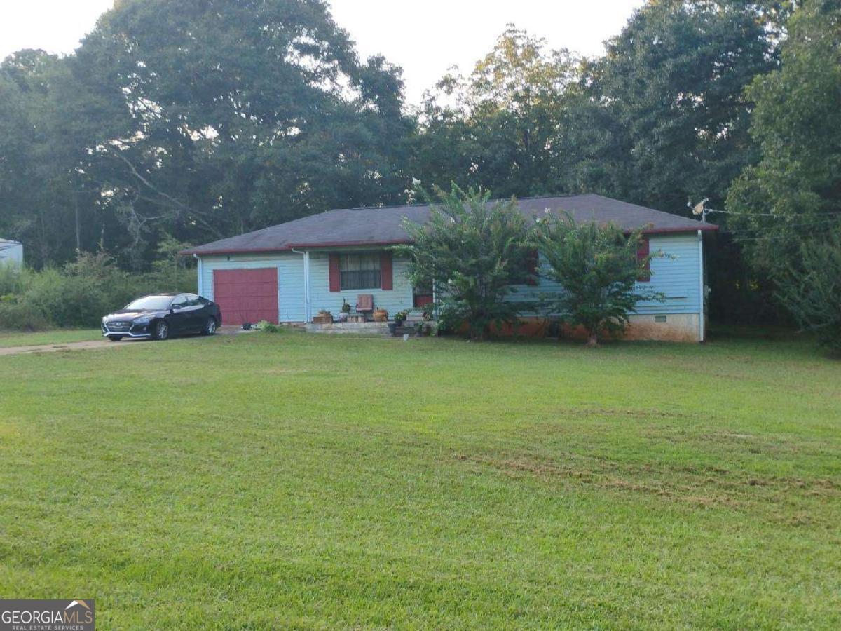 Charming Home on a Full Acre in Griffin, GA - Ideal for Homeowners or Investors! Welcome to 215 McIntosh Trail - A single-family home nestled on a spacious 1-acre lot in the heart of Griffin, Georgia. This 3-bedroom 2.5-bathroom home offers 1,225 square feet of comfortable living space, featuring central heating and cooling, and an attached garage. The home's siding and shingle roof add to its rustic charm, while the expansive lot provides ample room for outdoor living, gardening, or future expansion. ?? Location Highlights Located just minutes from downtown Griffin, this property offers the perfect blend of peaceful suburban living and urban convenience. Griffin is a growing city in Spalding County, just 40 miles south of Atlanta, making it a great option for commuters or those seeking a quieter lifestyle with access to the metro area. ?? Nearby Schools Jordan Hill Road Elementary Kennedy Road Middle School Spalding High School ??? Upcoming Developments & Growth Griffin is experiencing a surge in new construction, with over 70 new homes currently being built, including in nearby communities like Sun City Peachtree and Queens Bridge Way. These developments are bringing modern amenities, retail, and infrastructure improvements to the area, boosting property values and rental demand. ?? Why This Property is a Smart Investment Affordable Entry Point Rental Potential: Estimated rent is ~$1,472/month, making it a strong candidate for cash flow. Appreciation: Griffin home values have risen 13.2% year-over-year, with continued growth expected1. Migration Trends: Griffin is attracting buyers from major metros like New York, LA, and DC, increasing demand. Balanced Market: With rising inventory and stable prices, it's a great time to buy before the next upswing.