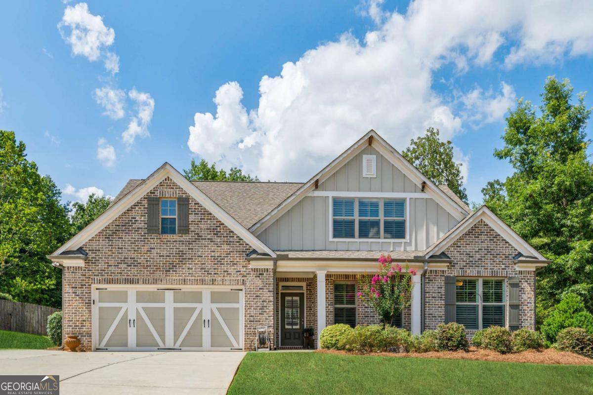 Welcome to your dream ranch-style retreat! This beautifully designed home offers a perfect blend of comfort, functionality, and style-set on nearly an acre of one of the most sought-after lots in the neighborhood. Step inside to discover an open-concept layout that's ideal for both everyday living and entertaining. The heart of the home is a spacious kitchen featuring a large island with a breakfast bar, sleek stainless steel appliances, on-trend white cabinetry, a classic subway tile backsplash, and a generous walk-in pantry. Just across the hall, you'll find a convenient mudroom with a built-in bench and extra storage-perfect for busy households. The kitchen flows seamlessly into the fireside family room, complete with custom built-in shelving and cabinetry, and a spacious dining area-making this space as functional as it is inviting. On the main level, you'll find three well-appointed bedrooms and two full baths, including a luxurious owner's suite. Enjoy dual vanities, a soaking tub, and a separate tile shower with frameless glass surround. Upstairs, a private haven awaits with a spacious bedroom, a full bath with tile flooring, and a versatile loft area large enough for a sectional sofa-ideal for a home office, playroom, or hobby space. Additional highlights include a main-level laundry room with built-in storage and sink, brand-new LVP flooring throughout the main level living area, the foyer, hallways, kitchen, dining, and the owner's suite. Step outside into your private backyard oasis-fully fenced and lushly landscaped, backing up to serene woods. Enjoy multiple outdoor living spaces including a covered patio, a separate grilling patio with sidewalk access to the expanded driveway, and a dedicated concrete pad perfect for a half-court basketball game, pickleball, or other activities. A storage building is also included for added convenience. This home offers a rare combination of space, style, and setting-don't miss the opportunity to make it yours!