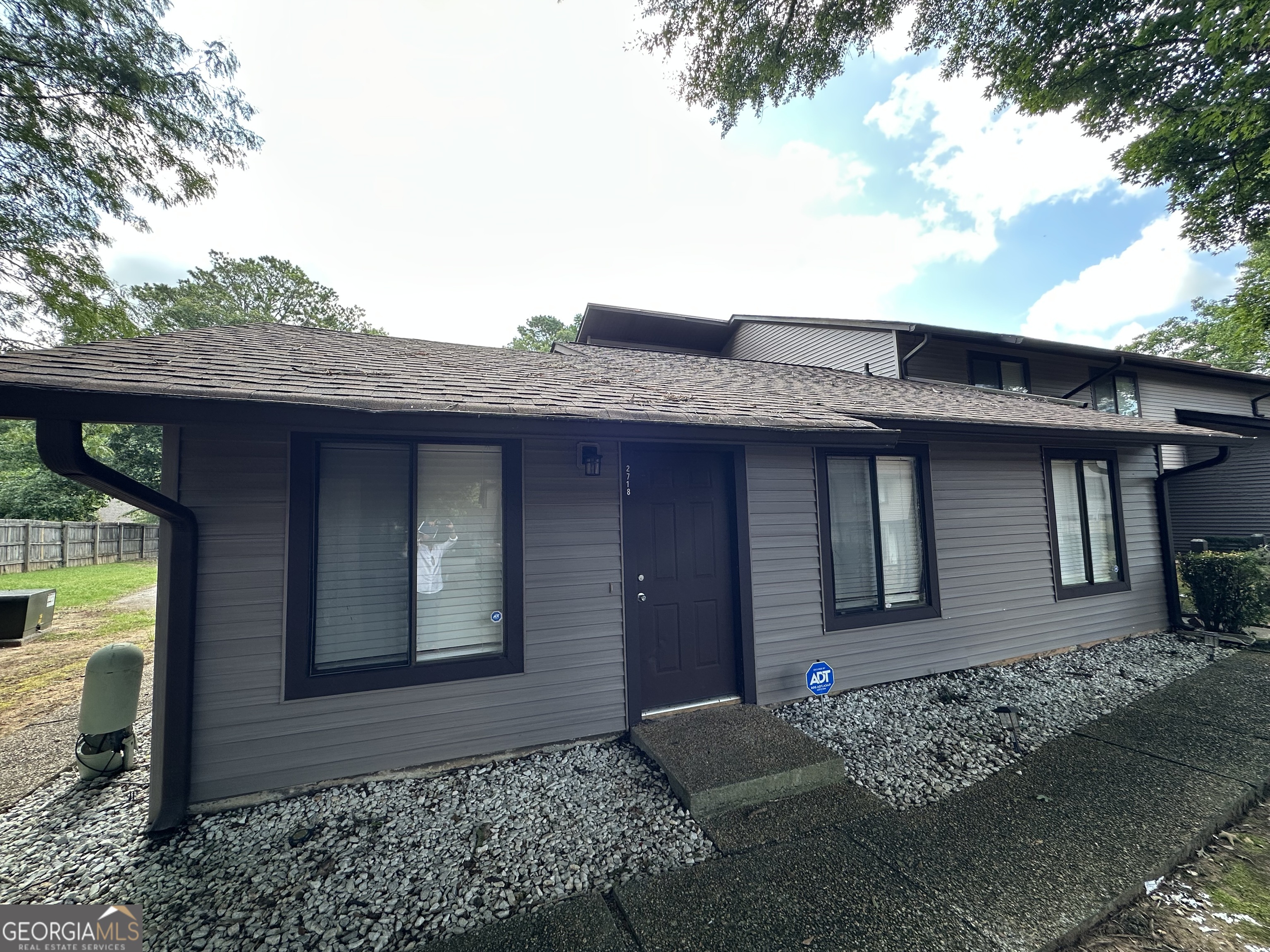 This property is a fantastic opportunity for buyers seeking value, comfort, and location.Originally listed as a 2-bedroom, 2-bath condo, it has now been thoughtfully updated to feature 2 bedrooms, 1.5 bathrooms, and a bonus room. The half bath includes a laundry area, and a previously existing shower was removed to maximize functionality.The home offers modern touches throughout, including LVP (Luxury Vinyl Plank) flooring, fresh interior paint, and granite countertops in both the kitchen and the primary bathroom. The kitchen cabinets have been fully repainted and updated, giving the space a clean and contemporary feel. Additional highlights include: ADT security cameras installed for added safety; All appliances included: refrigerator, dishwasher, and stove (all in excellent condition); Ceiling fans in both bedrooms; New HVAC unit and thermostat; A tenant-owned structure in the patio area (included with the sale); New fence; Two additional parking spaces; Mailbox #14 assigned to the unit; Wood-burning fireplace has been removed; Roof replaced by the HOA in November of last year. *This is a move-in ready unit in the Sweetwater Valley community - offering convenience, comfort, and great value.!