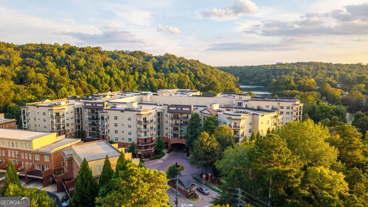 Life at One River Place... It doesn't get much better than this ANYWHERE. Welcome home to your special community situated right next to the iconic Chattahoochee River and so much more. This condo home is a premium, top level, corner unit. Exceptionally quiet. Two full bedrooms & Two full bathrooms with a modern, contemporary twist. Large owner suite with an impressive walk-in closet. Open concept living with a sleek and stylish kitchen island perfect for entertaining. Newer appliances that sparkle and shine. Upon request - SOLD FULLY FURNISHED. What really makes this property stand out? LOCATION, LOCATION, LOCATION. Five minutes away from The Battery at Truist Park. Five minutes from Cumberland Mall and the Cobb Galleria. Fifteen minutes to Buckhead. Easy interstate access. Fine Dining & Live Music - Walk to Rays On The River. Bike to Cochran Shoals Park for serene nature trails. Starbucks, Publix, first-class schools, you name it. It's all at your fingertips. A little slice of Heaven. You may never want to leave - immaculate grounds, fountains, barbeques, pools, fire pits, dog parks, meeting rooms, fitness center, cafe, spa, and more. Gated privacy & seclusion with a warm, neighborly atmosphere. Two deeded, covered parking spaces in the garage. Extra storage space available. Secure mail room. Friendly front desk reception. Think Four Seasons Resort everyday of the year. Plan your visit today to see why this hidden gem is one of North Atlanta's best kept secrets.