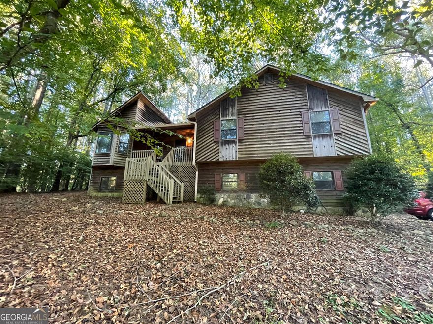 Investor special in Holly Creek Estates! This 3BR/3BA, 2000+ sqft rustic cabin-style home sits on over 1 acre of wooded privacy with tons of potential. Great bones and layout-ready for your renovation vision. Peaceful setting just minutes from downtown Woodstock, Lake Allatoona, shopping & I-575. Cash only, sold as-is. Perfect flip or long-term investment opportunity in a sought-after neighborhood. Act fast don't miss this rare opportunity!