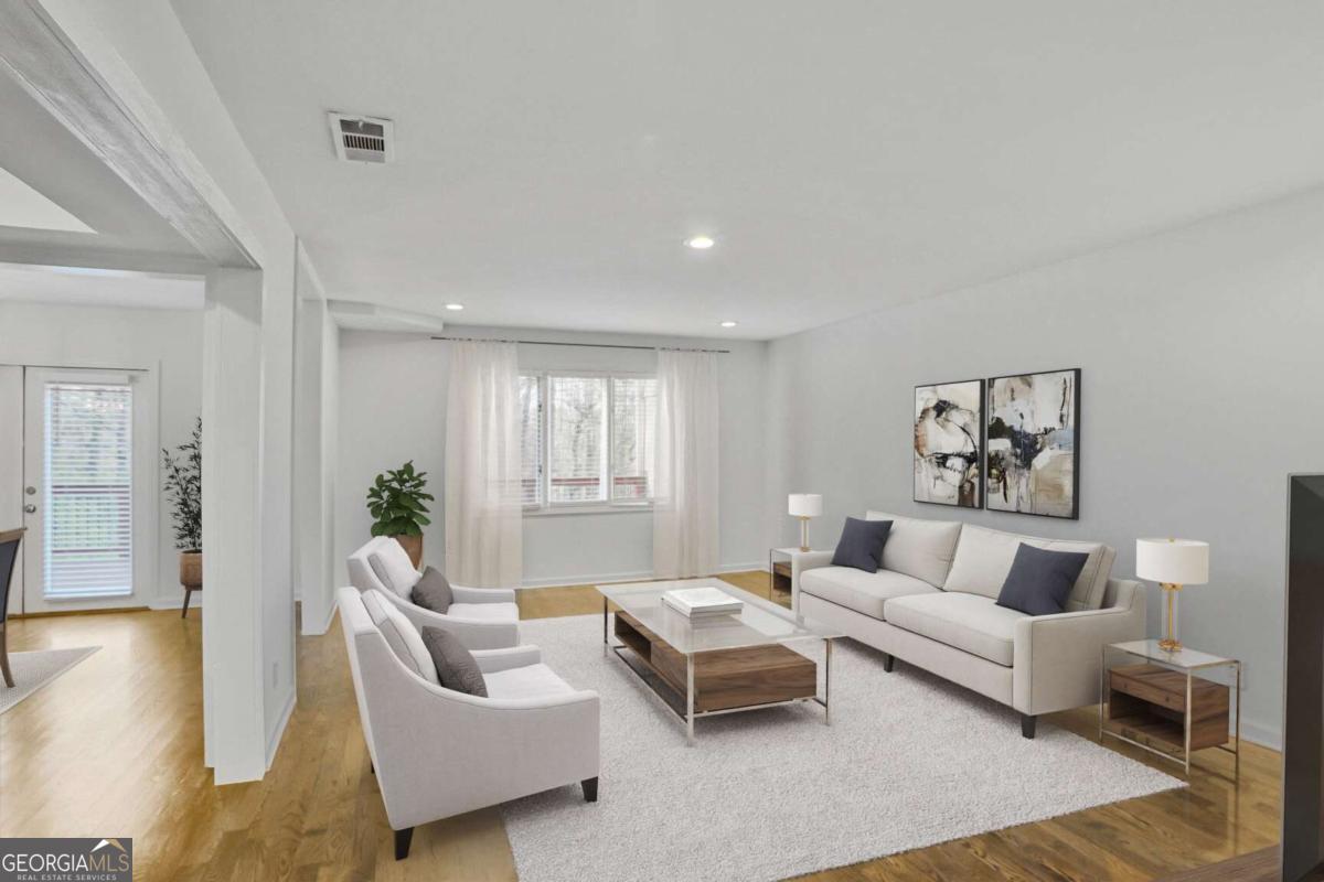 Welcome to life in the heart of Vinings. Wake up and head less than a minute down the road for coffee and a stroll through Vinings Jubilee. Grab lunch at your favorite local spot, catch a Braves game at Truist Park, and spend your weekend afternoons poolside-this is the lifestyle that comes with this well-located 2-bed, 2.5-bath townhome. This is truly a rare opportunity to own in Vinings at this price point with the bonus of space, storage and the potential to make it your own. Inside, you'll find hardwood floors throughout, updated lighting, and the kitchen overlooking the living room with quartz countertops, stainless steel appliances, gas range, and herringbone tile backsplash. The spacious dining area flows onto a freshly renovated back deck-perfect for unwinding with wooded views after a long day. Upstairs, vaulted ceilings add charm to the primary bedroom with ensuite bathroom. Downstairs, a mudroom entry and oversized two-car garage provide practical storage and everyday convenience. A proposed floor plan and contractor estimate are available to convert the main-level flex room into a true bedroom and full bath, creating a functional 3 bed / 3 bath layout. Plans also include a full renovation of the primary bath, giving you a clear path to add value and tailor the space to your taste. With unbeatable access to top-tier dining, shopping, and major highways, this is your chance to enjoy the best of Vinings at an affordable price-right outside your front door.