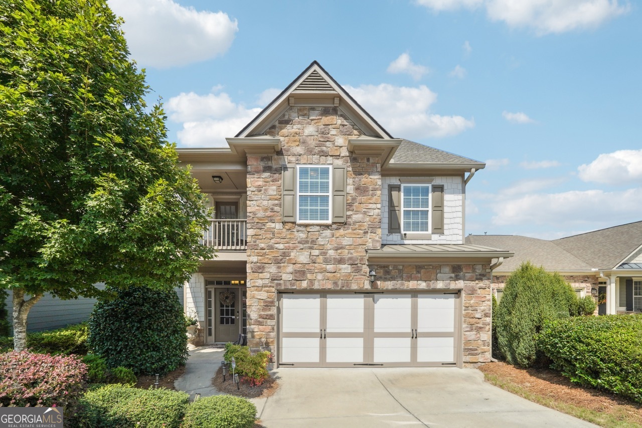 Welcome to Flowery Branch's vibrant, amenity-rich Sterling on the Lake community! This lovely three bedroom, two and one-half bath home will check off all the boxes! Enter the welcoming foyer leading to the cozy family room with stacked-stone gas log fireplace, on to the dining area and well-equipped kitchen featuring a breakfast bar, stainless appliances, gas range, pantry, and coffee nook. Upstairs, versatile loft space is ideal for home office or study space, and provides access to the balcony, the perfect spot for morning coffee or evening relaxation. The primary suite is a true retreat, oversized and luxurious with a tray ceiling, extended sitting area, large walk-in closet, granite topped dual vanities, soaking tub, and separate shower. Two additional bedrooms share a second full bath, and the laundry room is conveniently located on the upper level as well. Step outside to enjoy the private patio overlooking the level, fenced back yard. This home includes a fully automated security system that can turn on lights, open doors, and so much more! The roof was replaced a year ago, and the washer, dryer, and refrigerator will remain for your convenience. Landscaping is fully maintained by the HOA with a separate quarterly fee, offering low maintenance living at its best. Residents of Sterling on the Lake enjoy access to top-rated schools and a wide array of community amenities including four pools, miles of walking trails, eight tennis courts, six pickleball courts, movies on the green, its own Lake Sterling with private dock and fishing, and many more neighborhood events. Conveniently located near top rated schools, shopping, downtown Flowery Branch and both 985 and 85.