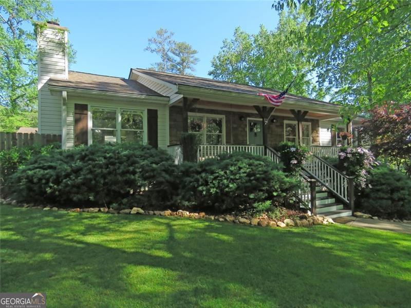 Location is Everything! Honey stop the car. Beautiful Ranch on a Basement next door to Lake Allatoona. Lake views and walking access to Harbor Town Marina and the Galts Ferry Public Day use boat ramp and picnic facilities. From the covered rocking chair front porch you will see lots of birds and deer everyday. Well maintained 3 bedroom, 2 Bath home with a full unfinished basement and newer, detached, 2 car Garage.  Beautiful kitchen with newer stainless steel appliances including the gas stove/oven. Roof 2020, water heater 2020 and recent septic system inspection and service. This home is move in ready. The Owners suite is spacious offering double vanities, and a large walk-in shower just completed. Large walk-in closet. The two other bedrooms are beautiful also with lots of space. This ranch home is completely stepless by entering from the detached garage. The basement has lots of room and deep enough to hold 3 cars for a total of 5 garage parking spots. Large, Lovely back deck with a Hot Tub that could be yours. Private, fenced back yard for everyone to enjoy. Schedule a showing now.