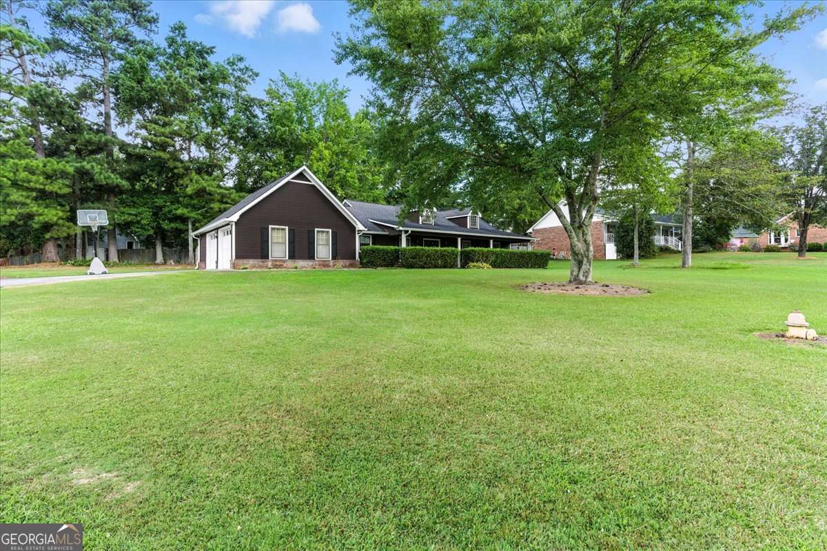 Charming one-level ranch in the desirable Northwoods Subdivision, located in the Armuchee School District. This home sits on a spacious corner lot and features a full-length covered front porch with two swings-perfect for relaxing evenings. Step inside to a welcoming foyer that opens to a vaulted living room with a cozy fireplace. The kitchen includes a sunny breakfast area and connects to a separate dining room for more formal gatherings. Down the hall are three bedrooms and two full baths, including an owner's suite with a walk-in closet. Out back, enjoy the patio and a handy storage shed.