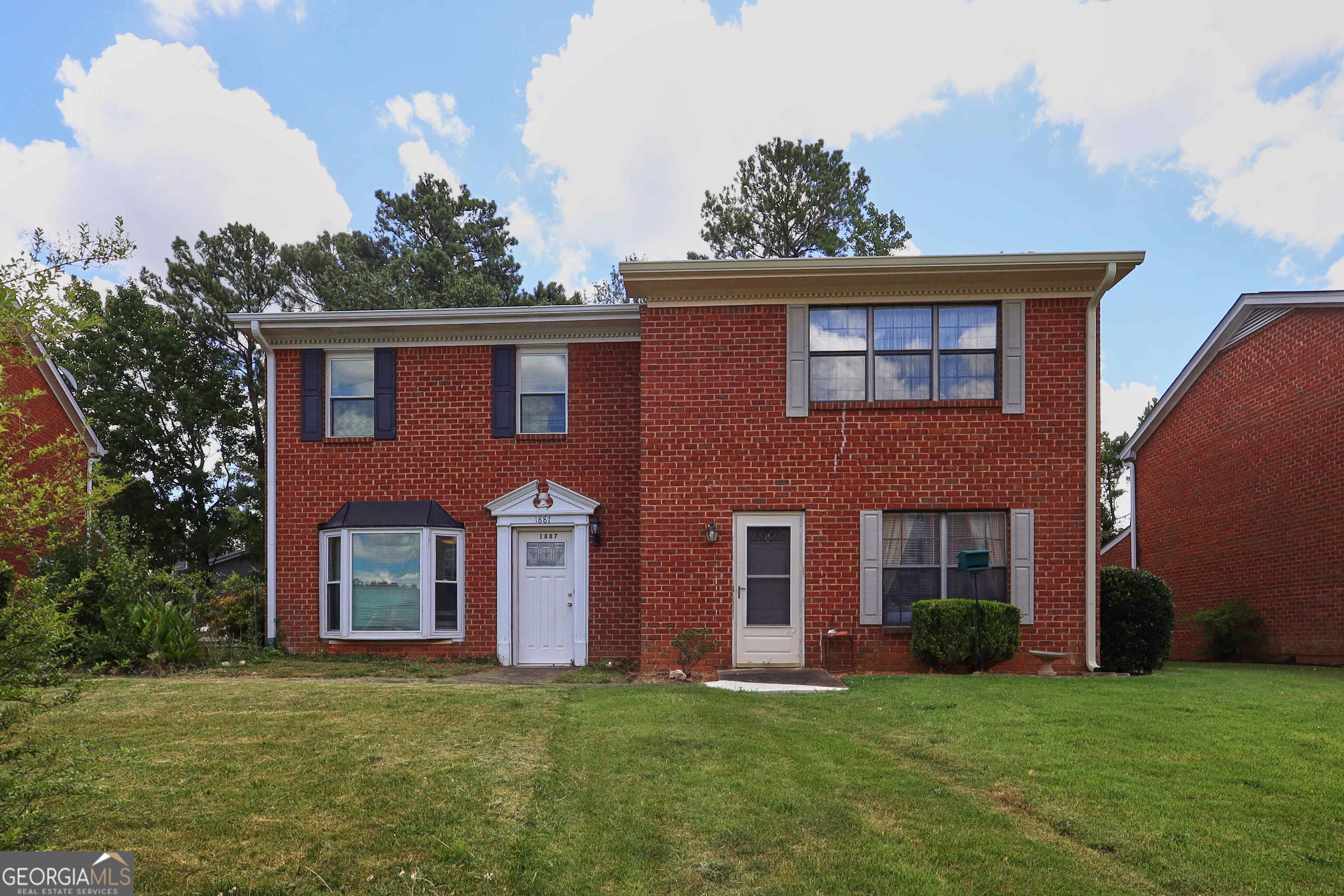 No HOA! Welcome to this beautifully updated 2-bedroom, 2.5-bath end-unit townhome in the heart of Lawrenceville. This three-sided brick home offers 1,340sqft of bright, open living space with wood floors, high ceilings, and a cozy fireplace in the main living area. New Paint, New Carpet and more updates. The kitchen features modern appliances and ample cabinetry-perfect for both casual dining and entertaining. A sunroom just off the living room fills the space with natural light, creating a serene spot to relax or work from home. Upstairs, you'll find two generously sized bedrooms, each with its own en-suite bath and walk-in closet-ideal for roommates or guests. Located just across from Gwinnett School of Mathematics, Science, and Technology, you'll enjoy easy access to top-rated Gwinnett schools, shopping, dining, and commuter routes-with no HOA fees to worry about. Whether you're a first-time buyer or investor, this townhome is a smart, stylish choice.