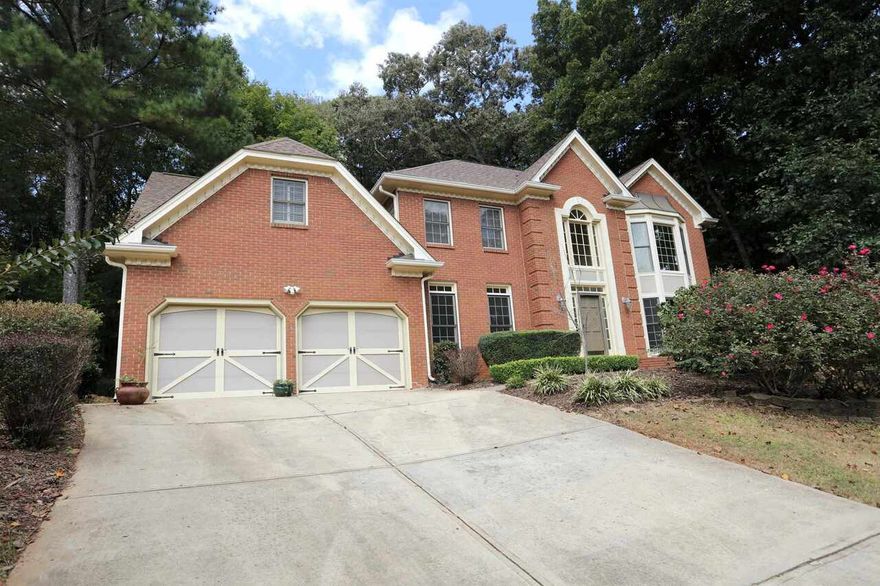 Take advantage of all the equity this home offers and make it your own!!! Spacious four bedroom home in Pope High School District Freshly updated with new carpet and paint throughout, this beautiful home is move-in ready! The inviting two-story foyer opens to a formal living room and dining room, perfect for gatherings. The large kitchen seamlessly connects to the family room, creating an open, comfortable living space. Upstairs, the primary suite features a bay window sitting area, a spa-like bath with soaking tub and separate shower, plus a generous walk-in closet. A private guest/teen suite with its own full bath and stairs to the kitchen offers added flexibility. Enjoy outdoor living with a screened porch, open deck, and private backyard, ideal for relaxing or entertaining. The basement provides abundant storage. Located in the highly sought-after Pope High School district, this home offers both comfort and convenience.