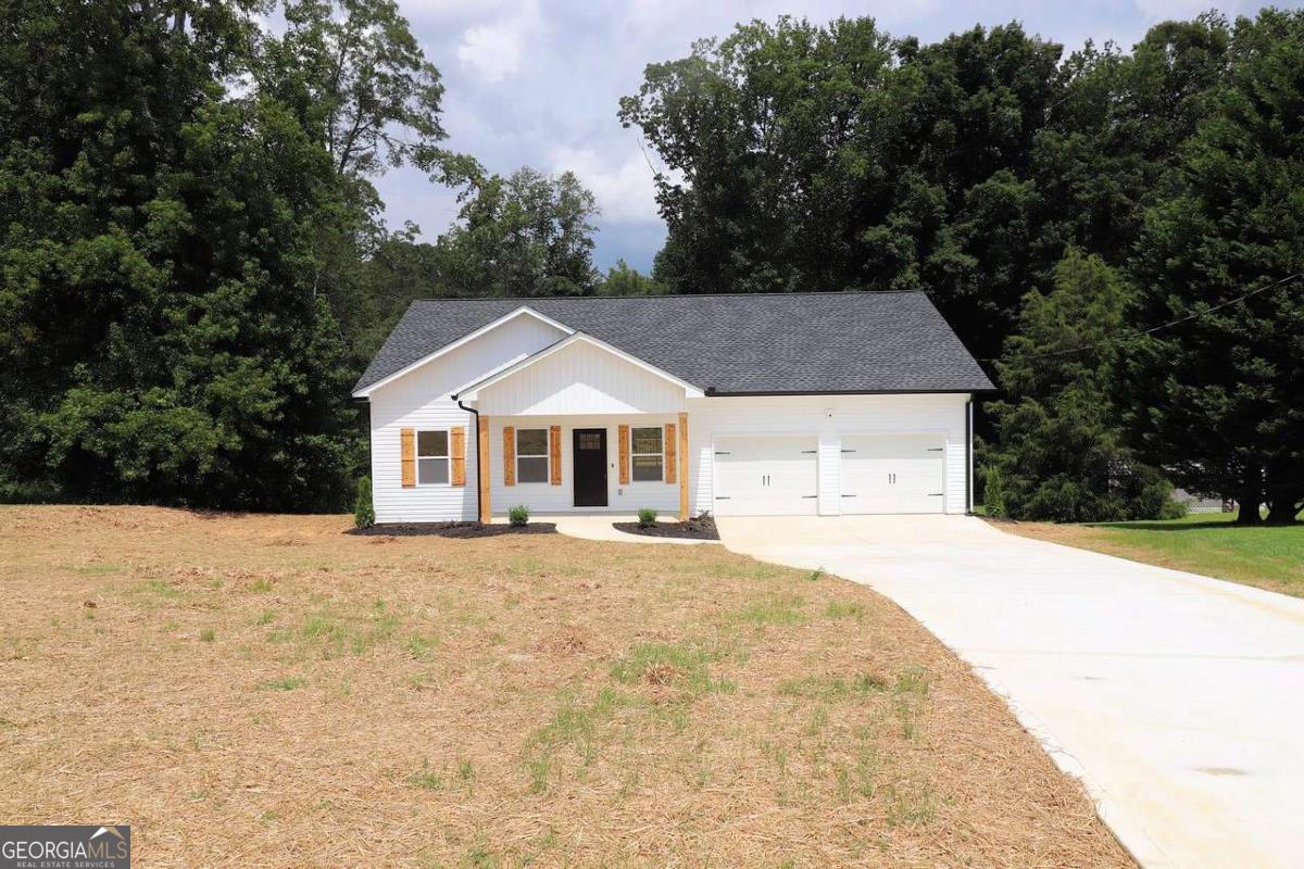 Located 5 minutes south of I-20 Exit 11, this new Ranch Home on a 1.24 acre lot has all the extra details. The best detail is it qualifies for USDA 100% no money down financing! Kitchen features Granite counter tops, ceramic tile back splash, stainless steel appliances, and a large center island. Whirlpool Gold Appliance package includes a French Door refrigerator and Front Load washer and dryer. Primary Bedroom features a large walk-in closet with 2 rows of shelves. Both bathrooms feature real ceramic tile showers, glass block privacy windows, and high efficiency toilets. Remote control ceiling fans/lights are in the living room and three bedrooms. Huge attic includes pull-down attic stairs and extra plywood flooring for storage. 2 car garage features windows, shop lights and Wi-Fi auto garage door openers. A big 12x16 deck looks over the peaceful back yard. Ring cameras are actively watching the exterior for security. AT&T Fiber internet is installed and active. All electric home. Heat Pump. 50 gallon water heater. 1445 sq ft heated living space plus a 302 sq ft garage. This beautiful new home includes a 1 year Builder warranty.