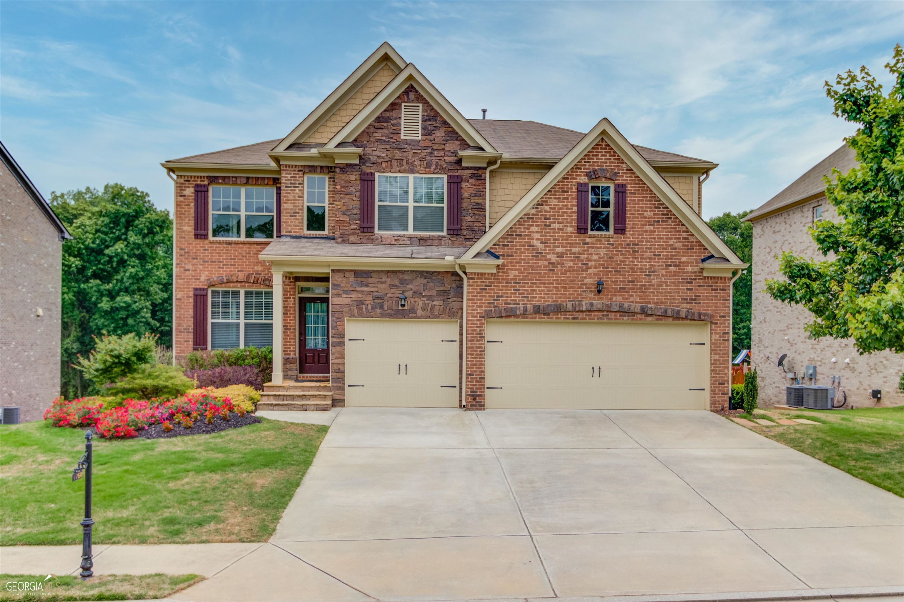 BUFORD CITY SCHOOLS, Beautiful In Ground Pool, Freshly Painted Interior, Newly Carpeted Upstairs and in the FULLY FINISHED BASEMENT, Hardwood Floors throughout main floor. The basement was finished by the builder and matches the upper floor finish. Move right in and enjoy your summer at your very own gorgeous pool. Close enough to walk to sought after Buford High School as well as the grocery store. Natural light pours into the entryway, receiving room through towering windows. The main floor features hardwood floors throughout its open floor plan. The upgraded trim package, coffered ceilings in the Dining room, and custom built-ins around the fireplace all elevate the main floor. This is the perfect space for entertaining. Enjoy an oversized granite island in your kitchen which opens to the breakfast area and a large family room with natural light from the wall of windows overlooking the pool and meadow. Also on the main floor is a large bedroom featuring a massive closet with custom built-ins. Directly next to that room is a full bathroom to one side and mud room access to the garage on the other. Upstairs you will find 4 large bedrooms around the corners of a massive loft area. Experience the CONVENIENCE of having the laundry room easily accessible to most of the bedrooms in the house. The owner's suite bathroom has been updated to include a large Mariposa soaking tub, custom tile work, and bench in the frameless glass shower. There is a full bathroom next to one of the secondary bedrooms as well as a jack and jill full bath between the other 2 remaining bedrooms on that floor. The full finished basement boasts an oversized bedroom and huge closet along with a large open room which is wired for surround sound. There is one storage room which easily fits 6 storage shelves as well as 2 smaller finished rooms great for workshops or playrooms. Walk outside your basement door and enjoy your own private sanctuary. The gorgeous pool has a large sundeck with bubbler, 2 waterfalls, and 2 natural gas lit fire pots. The yard has been thoughtfully landscaped to include retaining walls, flower beds, luscious trees, and xenon zoysia grass as well as a 6-zone irrigation system. The yard is fenced by a freshly painted wooden privacy fence. There's nothing to do but unpack and relax. Welcome Home!