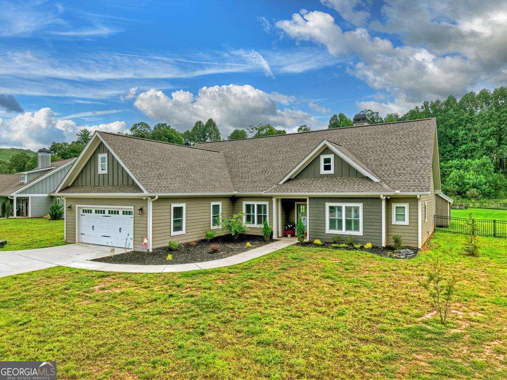 Cozy 3BR/2BA Ranch-Style Retreat near Blue Ridge & Blairsville. Welcome to this bright and spacious one-level home, ideally located just 2 miles from Hwy 76 for quick access to both Blue Ridge and Blairsville. Tucked away in a quiet subdivision off Dean Gap Road, you'll enjoy peace and privacy surrounded by newer homes and picturesque pasture land - all with no road noise. Step inside to find a thoughtfully designed interior featuring luxury vinyl floors, vaulted ceilings, plantation shutters, and abundant natural light. The living area showcases a woodburning fireplace for cozy evenings, while the kitchen and baths boast custom cabinetry, double vanities, and a beautifully tiled shower. The fenced backyard is perfect for pets, play, and gatherings. Two sheds provide endless possibilities: the larger shed is fully insulated, drywalled, and equipped with 30amp service - ideal for a home gym, office, or homeschool classroom. With ample storage, modern finishes, and inviting living spaces, this home blends comfort, style, and convenience in one perfect package.