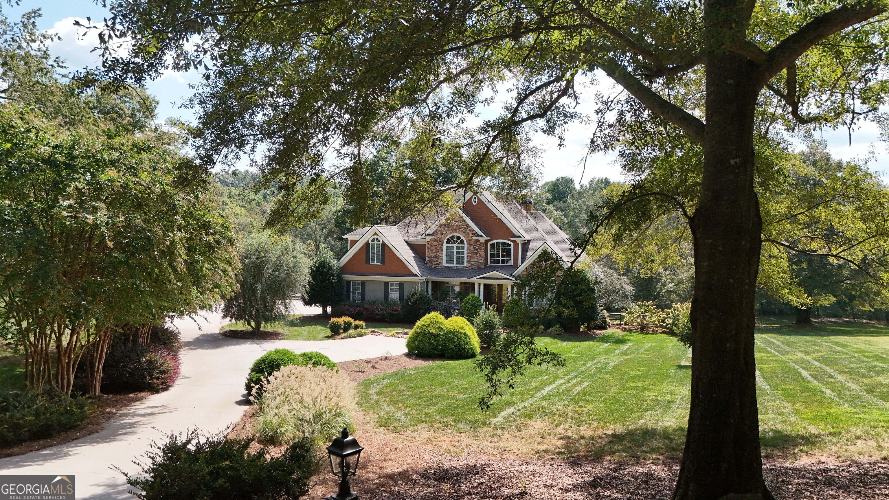 Nestled at the end of a quiet road on the serene Soque River, this meticulously maintained home offers the perfect blend of comfort, elegance, and privacy. Surrounded by nature and completely free of traffic, the property sits on a level lot ideal for children, pets, entertaining, or simply enjoying peaceful riverside living. From the moment you walk through the door, you'll feel instantly at home - the warmth of natural stone accents, high ceilings, and three stunning rock fireplaces with gas logs create a cozy, welcoming atmosphere. The main living area is spacious and filled with natural light thanks to floor-to-ceiling windows that offer breathtaking views of the sun, moon, stars, and sky. A custom rock fireplace anchors the large living room, while a separate den with its own fireplace offers additional space to relax. Additionally, the open and thoughtful layout flows effortlessly, boasting a den, large chefs kitchen with an island and walk in pantry, oversized mud room with additional storage/laundry area, formal dining area, casual dining area/breakfast table, master bedroom with a master en suite and half bath, making it perfect for hosting gatherings both large and small. A separate office provides a quiet, dedicated space for work or study, and elegant tray ceilings elevate the aesthetic throughout the main floor. Upstairs, guests will appreciate three generously sized bedrooms, two full bathrooms (including one en suite), and a versatile loft area that can be used for hobbies or additional sleeping space. The lower level features a bright and peaceful sewing or craft room with ample cabinetry and a full bath nearby, along with a fully wired woodshop equipped for all your tools - including hookups for an air compressor and dust collection system. Adjacent rooms offer plenty of space for storage of wood, paint, or other supplies. A finished sitting area with a TV and sectional sofa provides a perfect retreat for kids to enjoy games or movies away from the main living areas, and a huge storage area ensures space for everything. Outdoor living is just as exceptional, with two separate decks for grilling and entertaining, and a screened porch with sliding windows that let you enjoy fresh air nearly year-round. The beautifully landscaped yard leads down to the river, offering a perfect backdrop for family cookouts, playtime, or quiet reflection by the water. With three HVAC units, abundant closets, ceiling-high windows, and thoughtful design throughout, this home offers both luxury and livability in a peaceful, nature-filled setting. Whether you're seeking a full-time residence or a weekend retreat, this rare Soque River property has everything you need to feel at home, every day.
